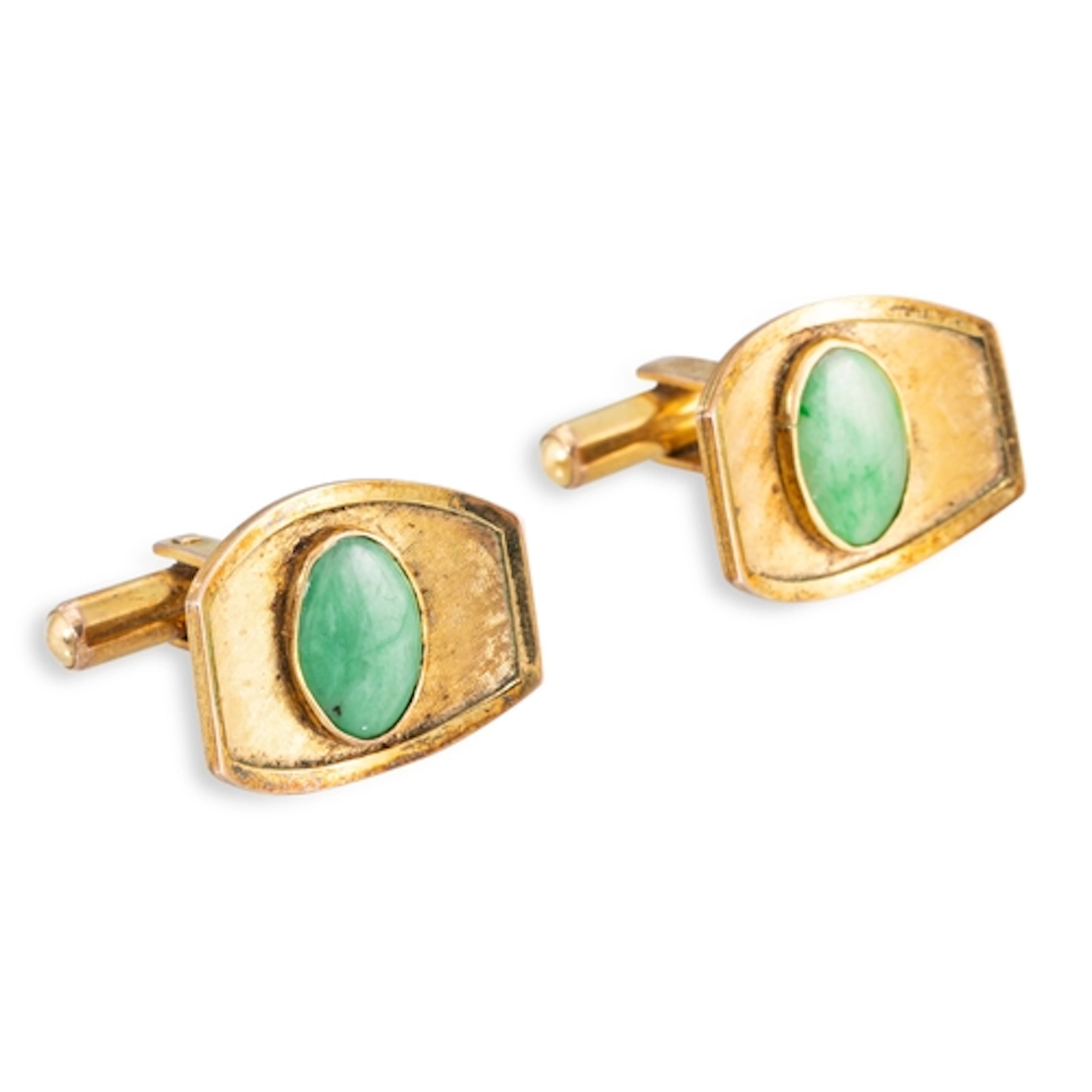 A PAIR OF JADE CUFFLINKS, the oval cabochon jade to concave ...