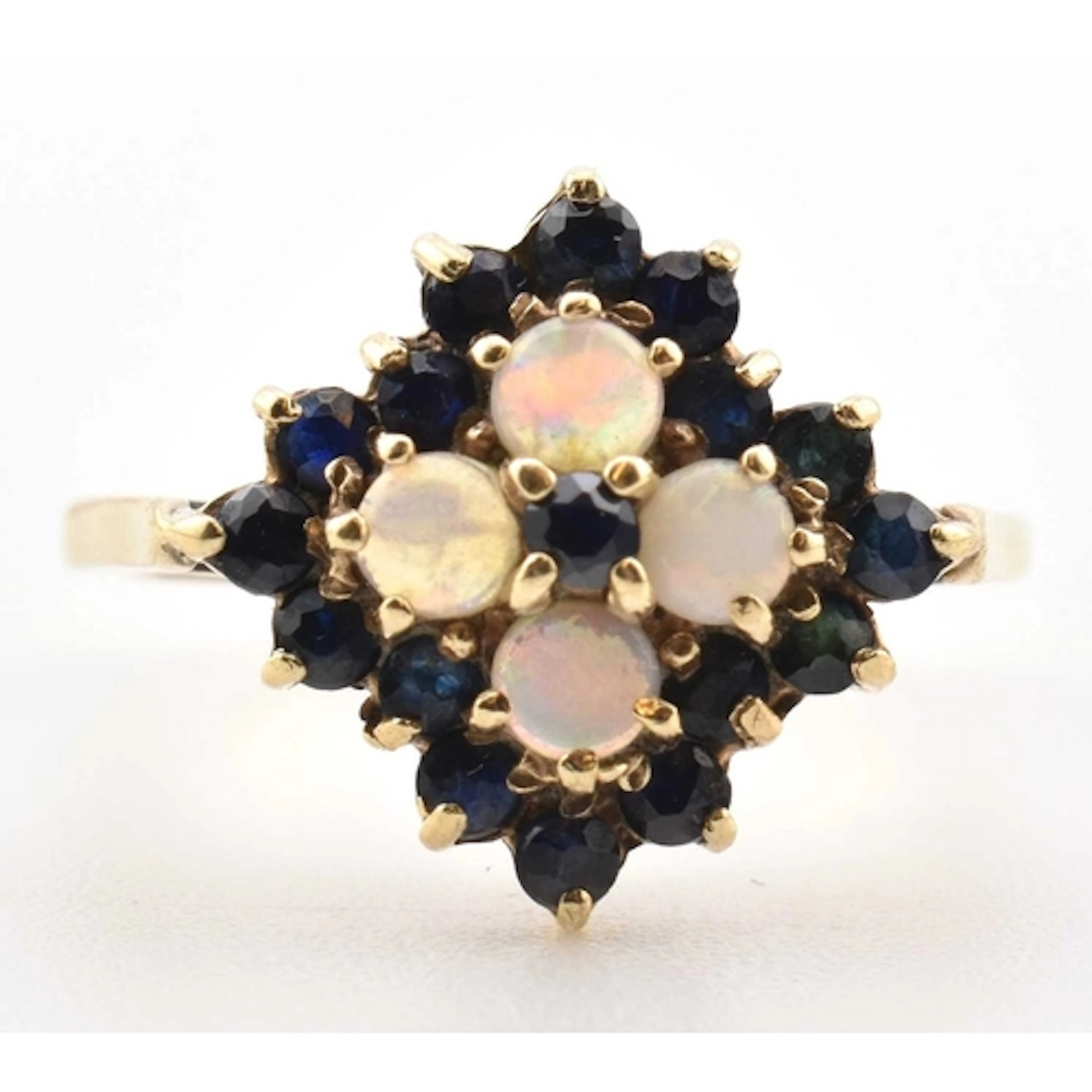 A 1970s hallmarked 9ct gold opal and sapphire cluster ring. ...