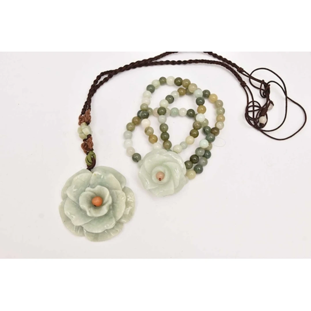 TWO ITEMS OF JADE JEWELLERY, to include a carved jade flower...