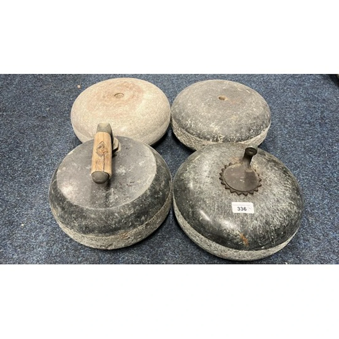 Group of four curling stones.