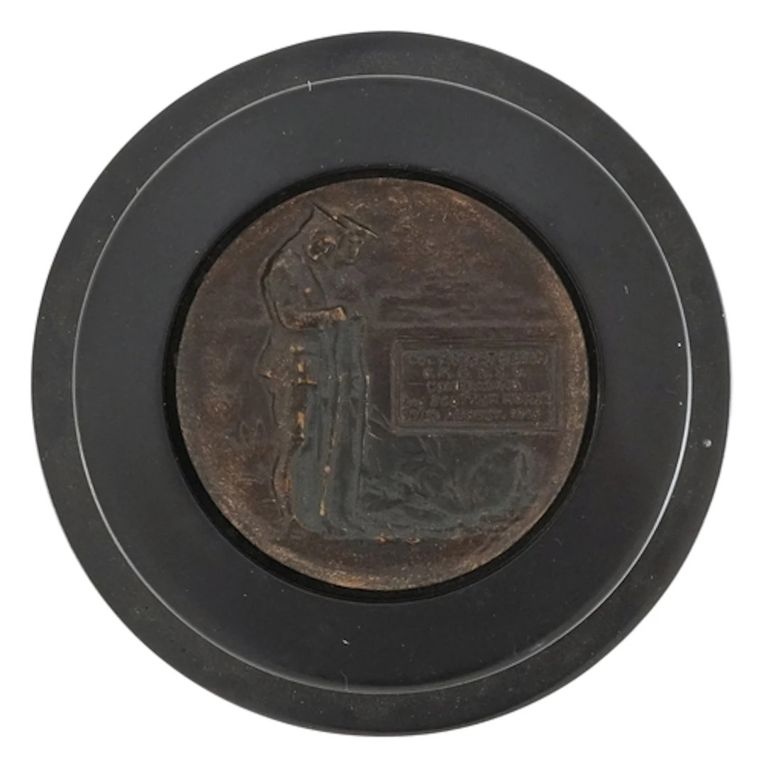 Military interest patinated bronze plaque in an ebonised cas...