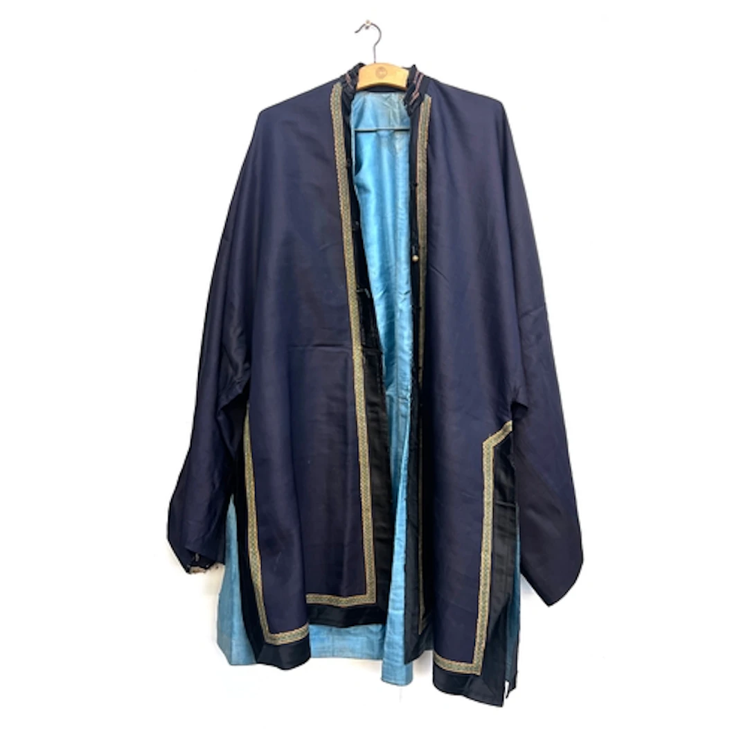 An antique Chinese navy blue silk robe with light blue linin...