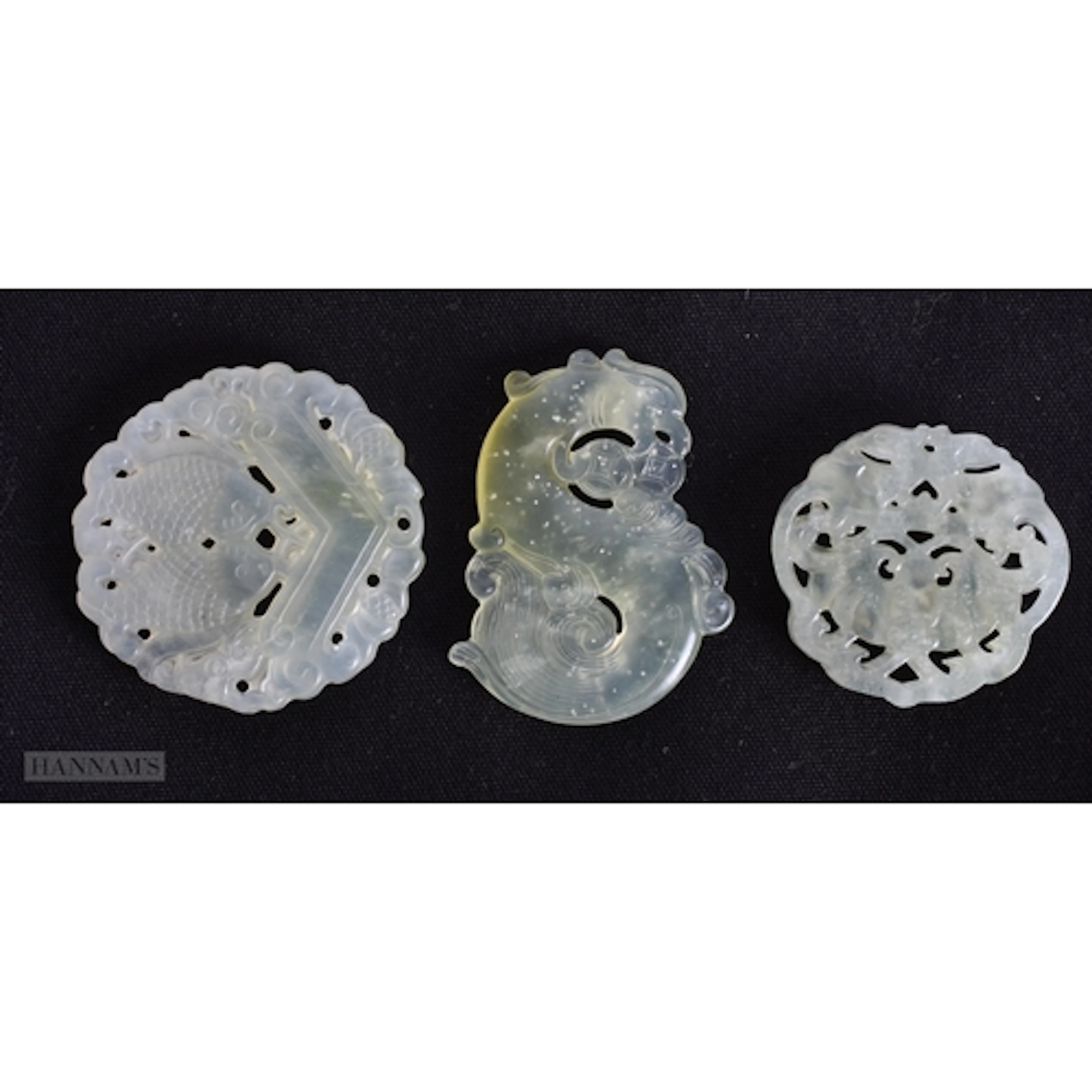 THREE CHINESE PIERCED JADE PLAQUES. 4.8 x 0.6 cm. (3)