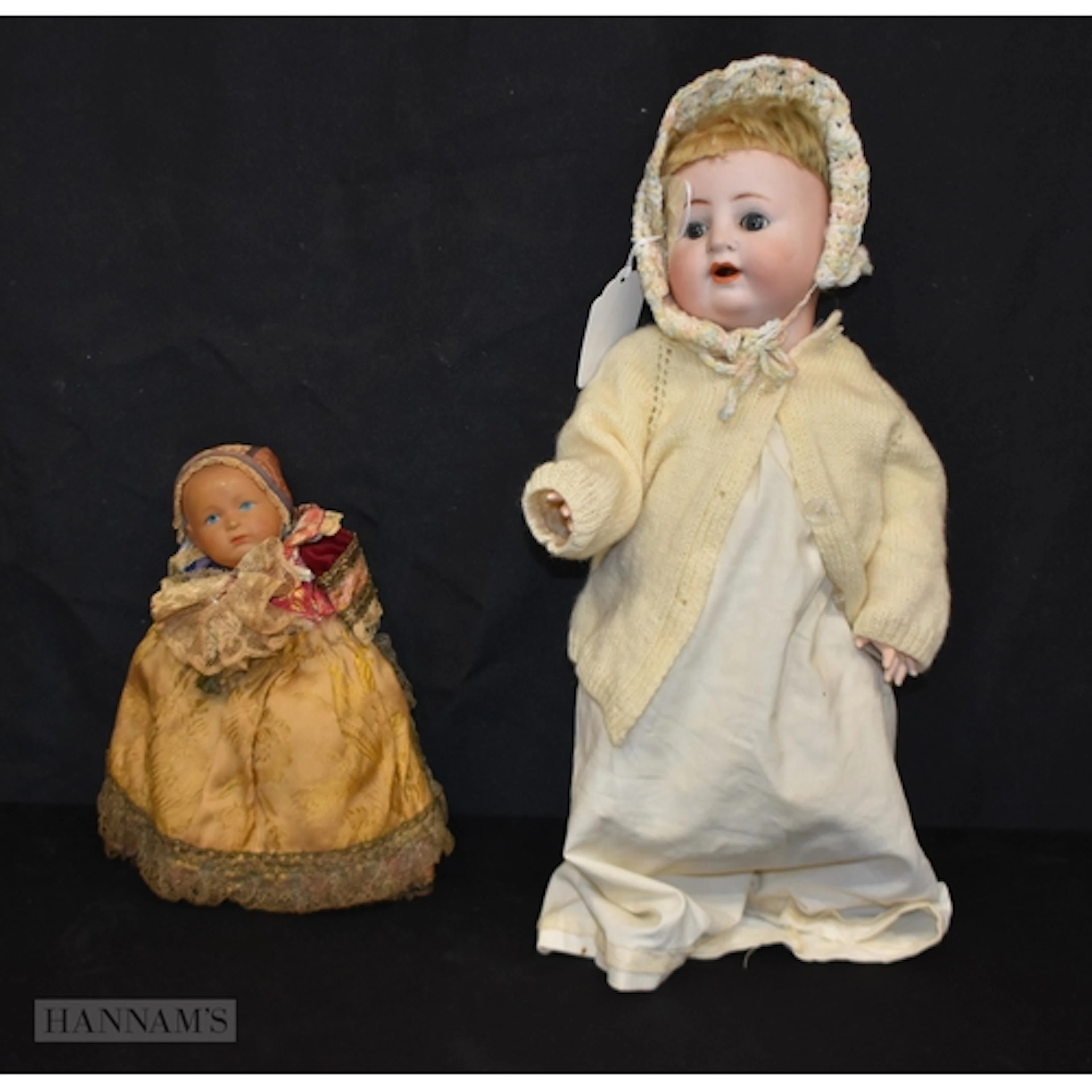 An antique Bisque head doll together with another vintage do...