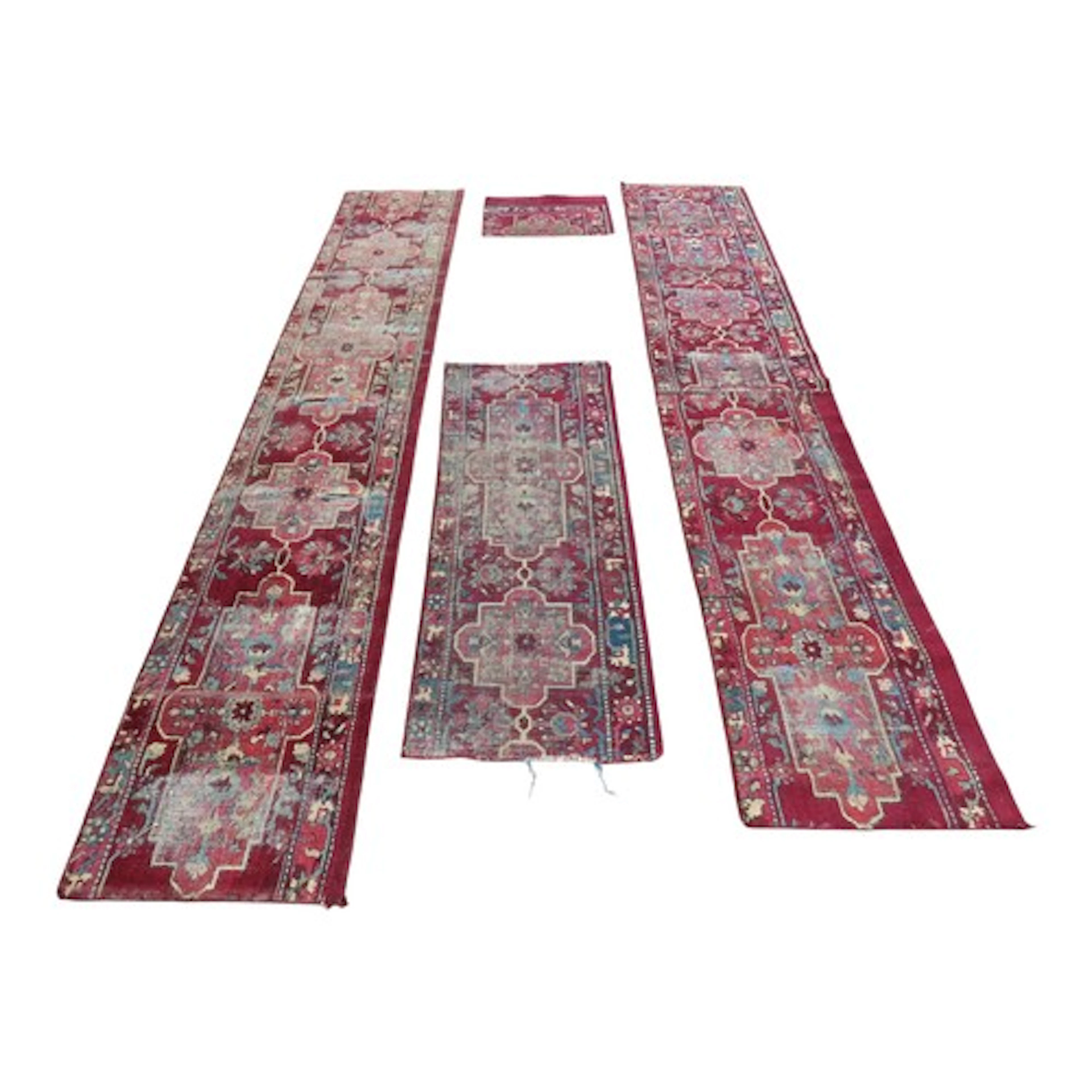 Four antique Indian Agra carpet fragments used as stair runn...