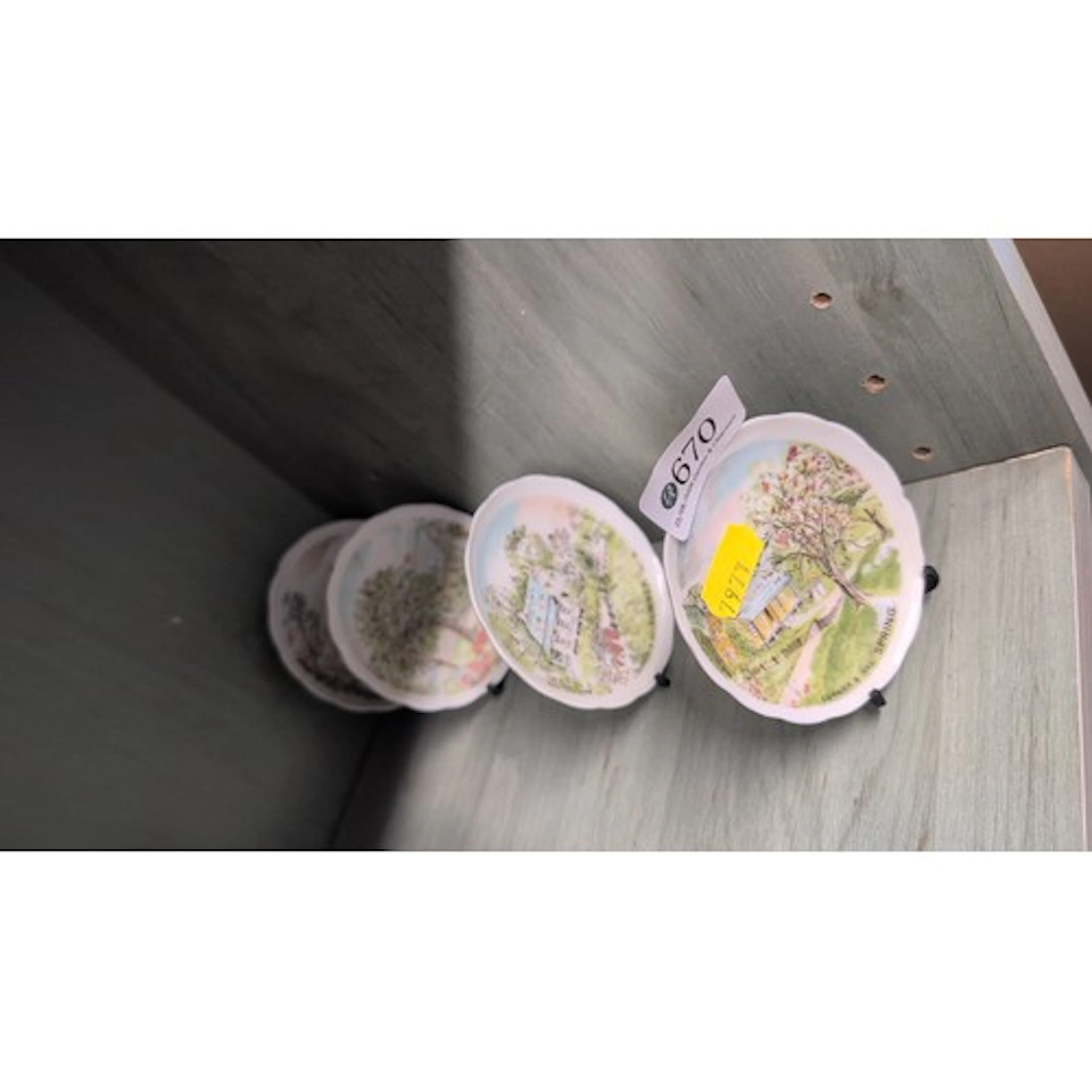 A set of four scalloped-edge porcelain collector’s plates, t...