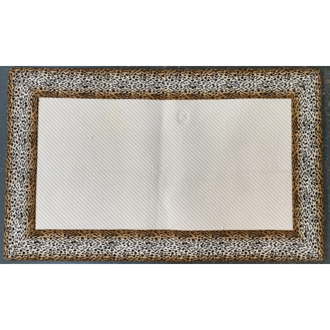 A woven rug with cheetah print border, 92x150cm