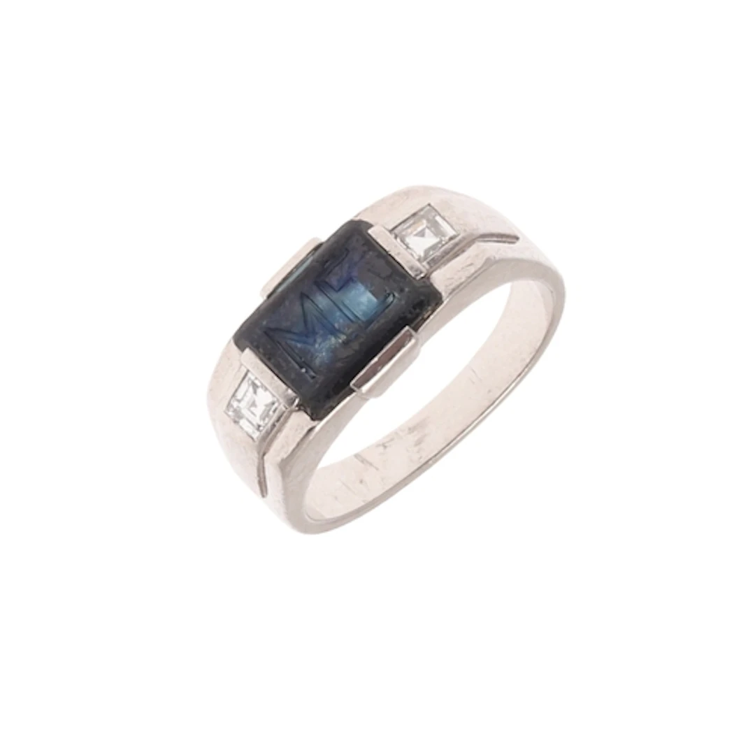 A BLACK ONYX AND DIAMOND SIGNET RING. the rectangular-shaped...