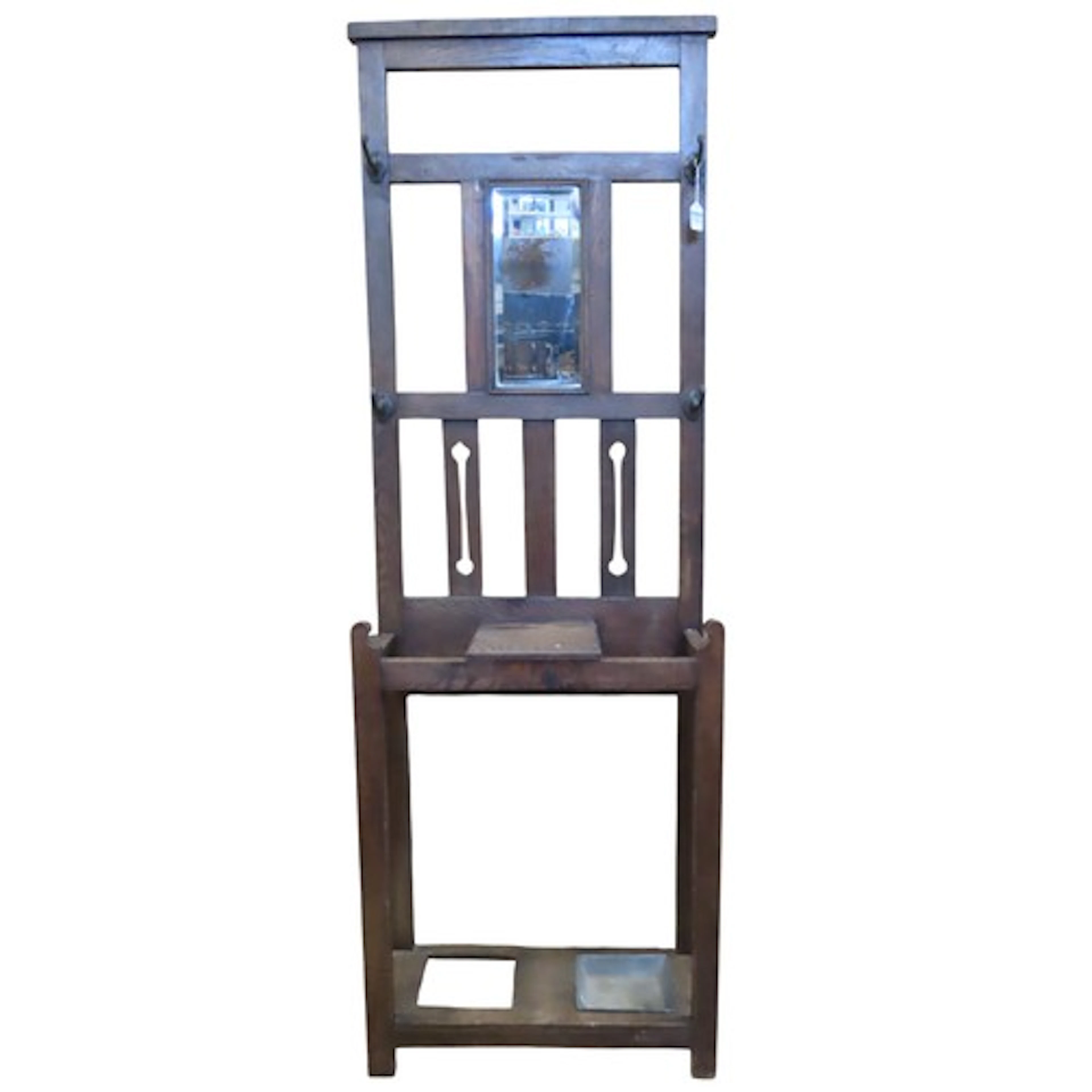 An oak Arts & Crafts style hallstand with pierced detail and...
