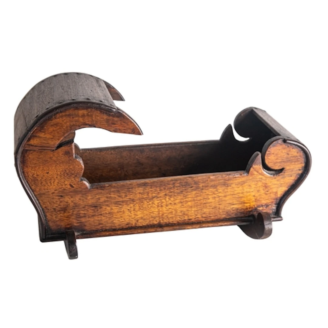 A stained walnut model of a crib in early 18th century taste...