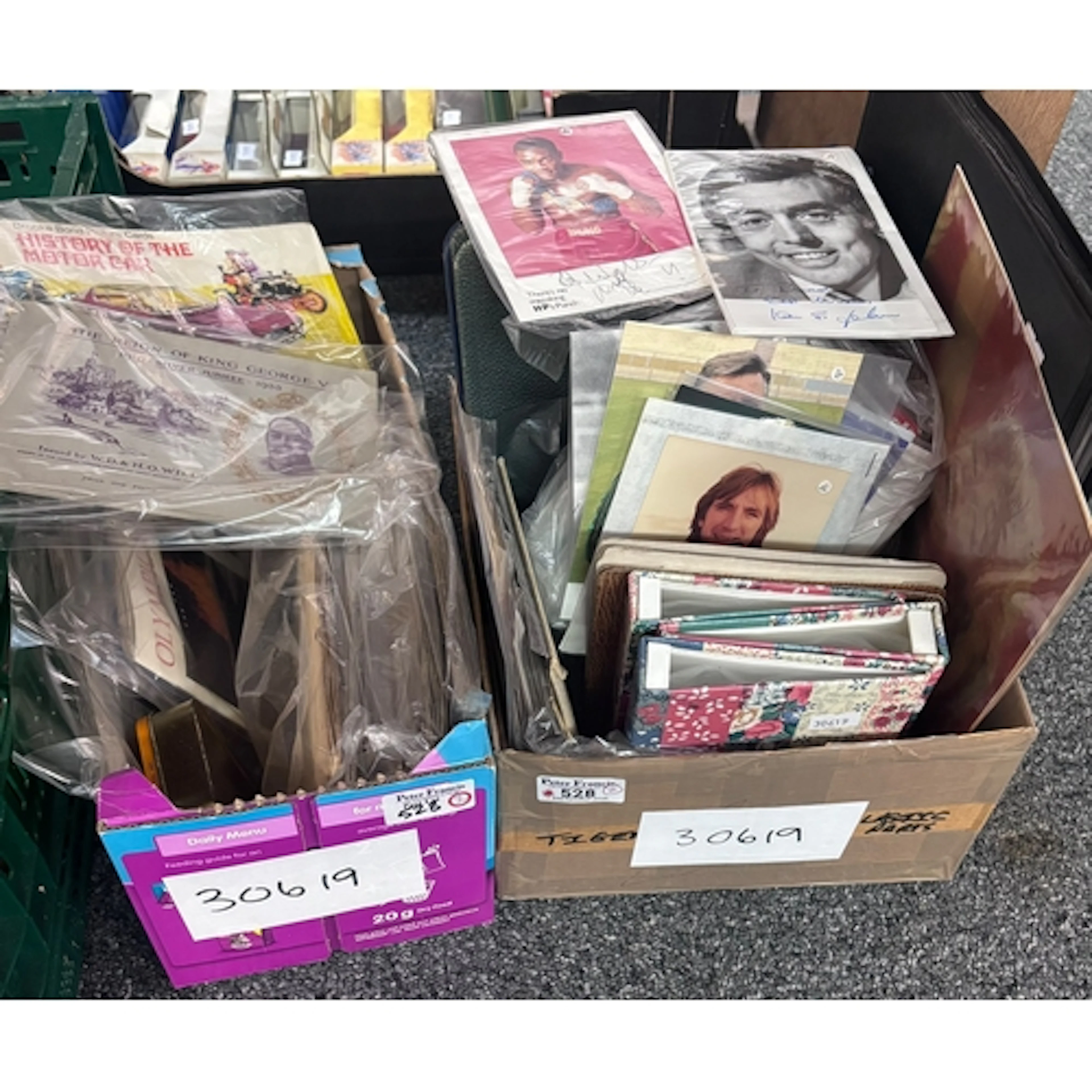 Two boxes of assorted cigarette cards, empty cigarette album...