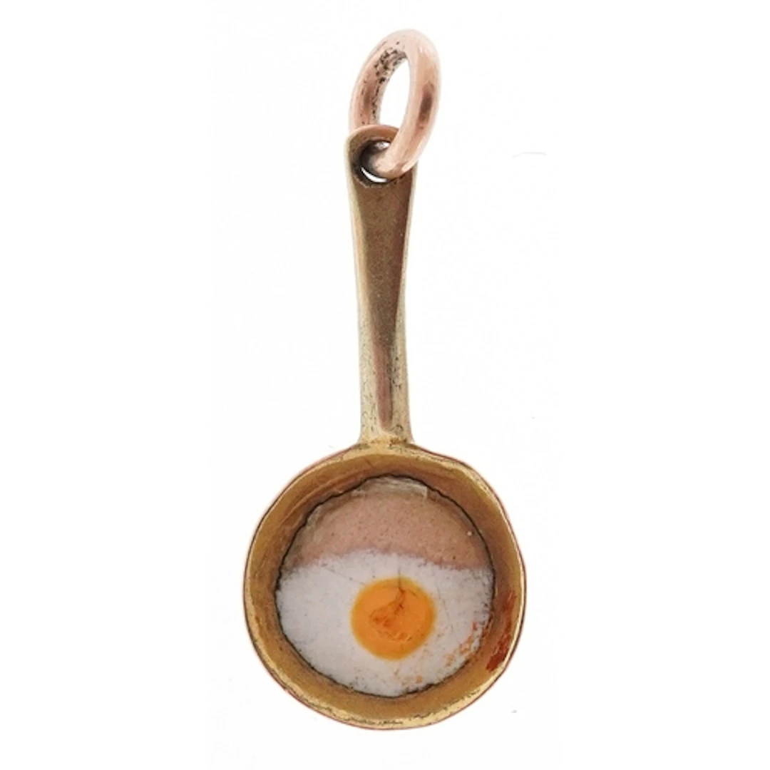Unmarked gold and enamel charm in the form of a fried egg in...