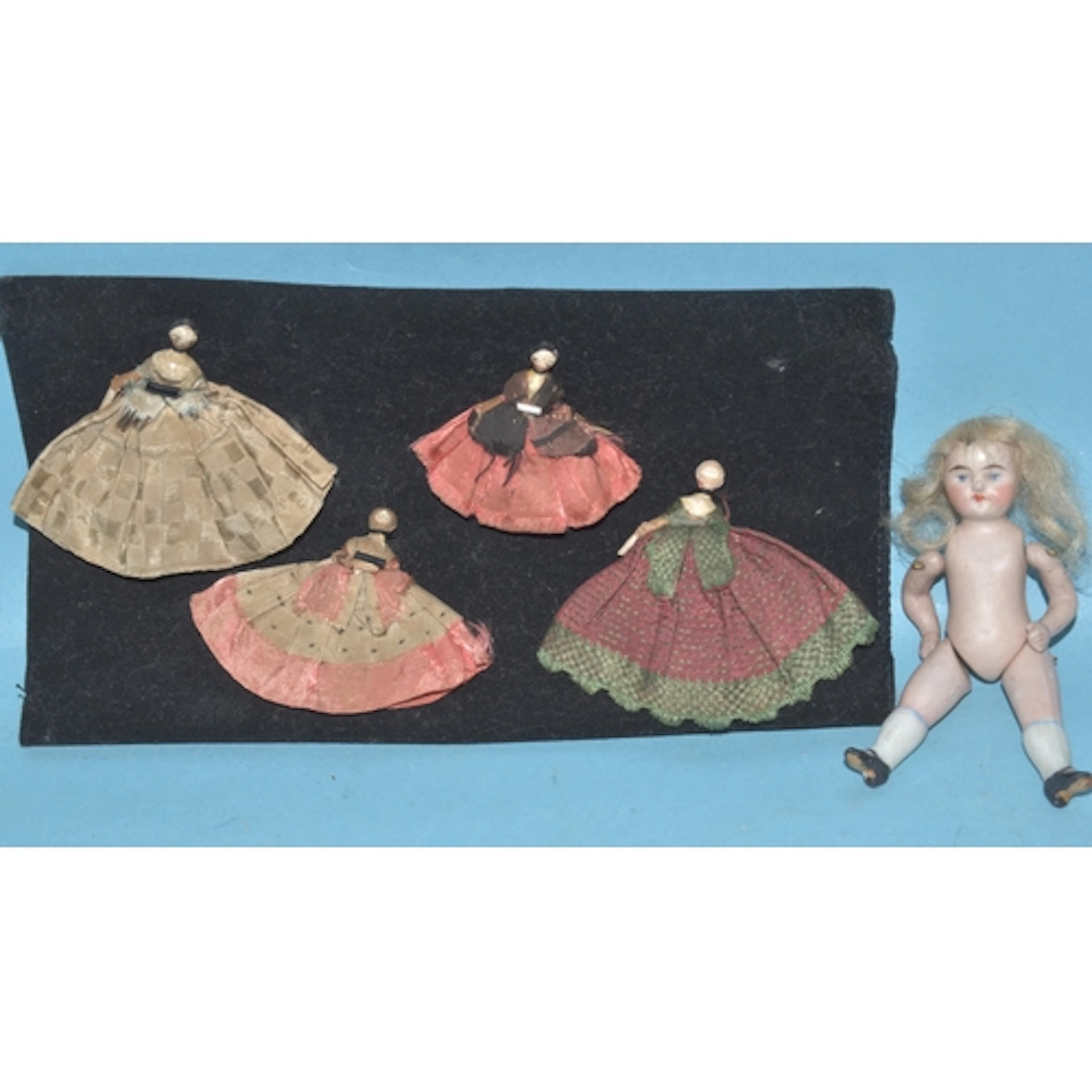 A Victorian all-bisque doll's house doll, 9cm long and four ...