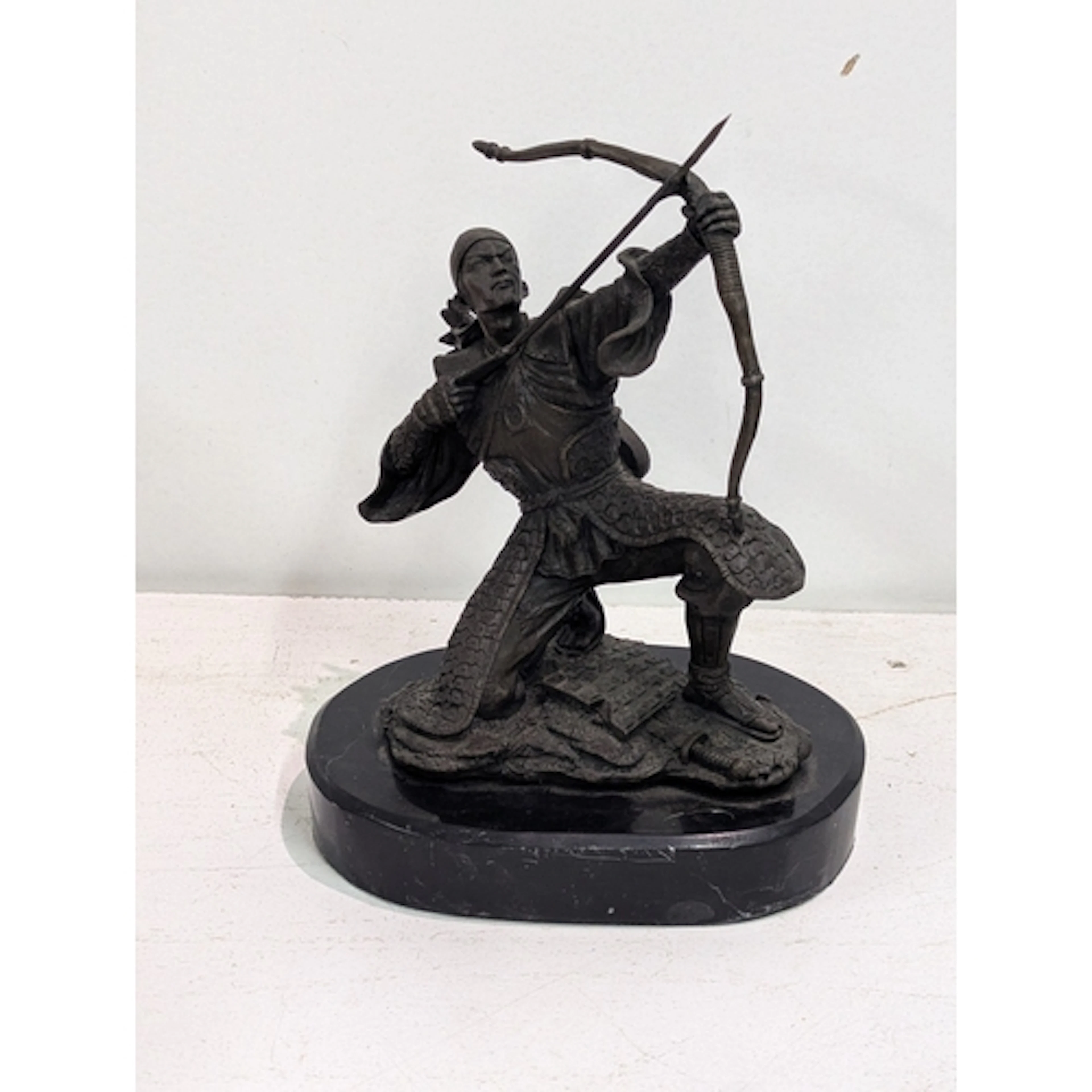 A bronze kneeling Japanese Samurai archer drawing a bow, sig...
