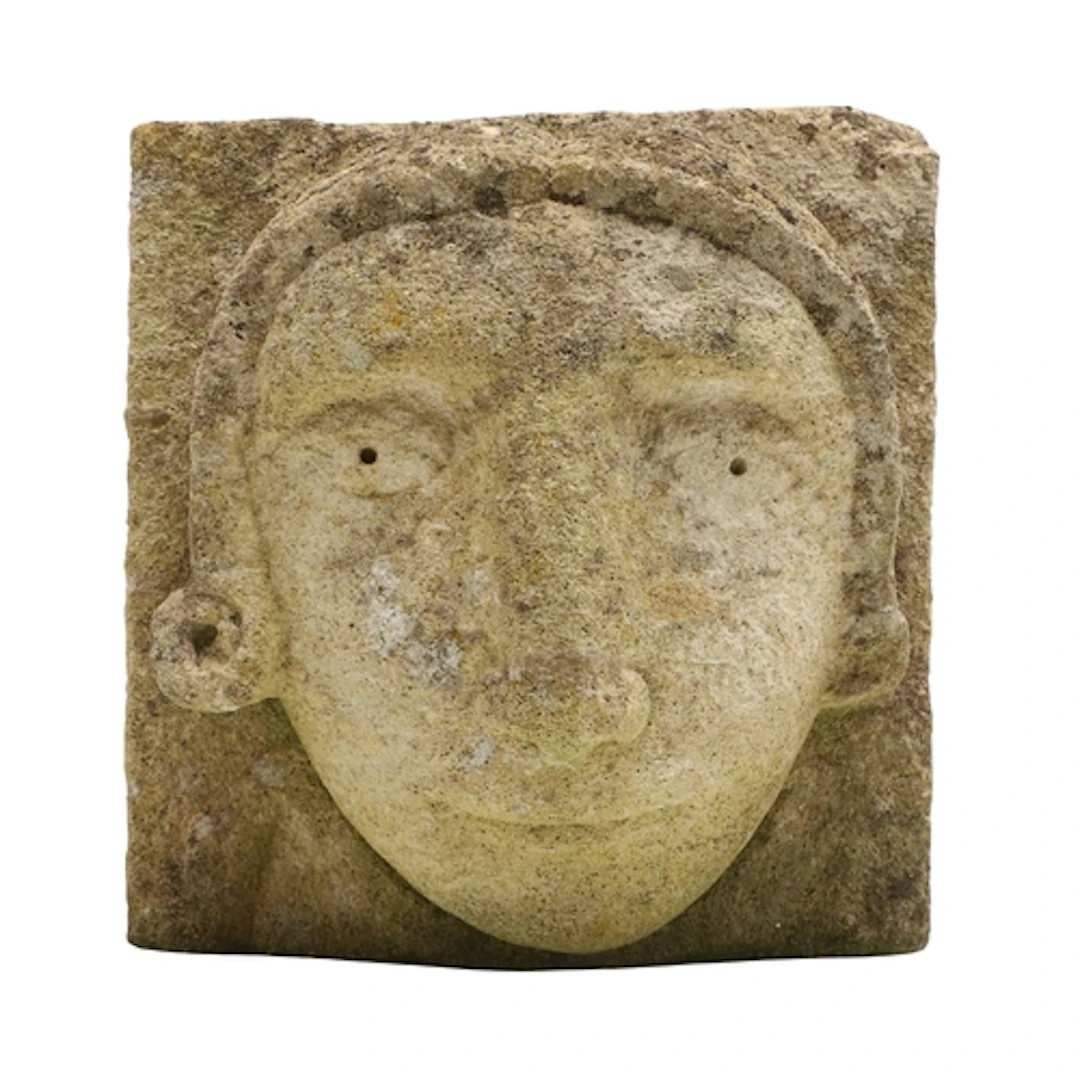 A MEDIEVAL STYLE CARVED STONE CORBEL. depicting the head of ...
