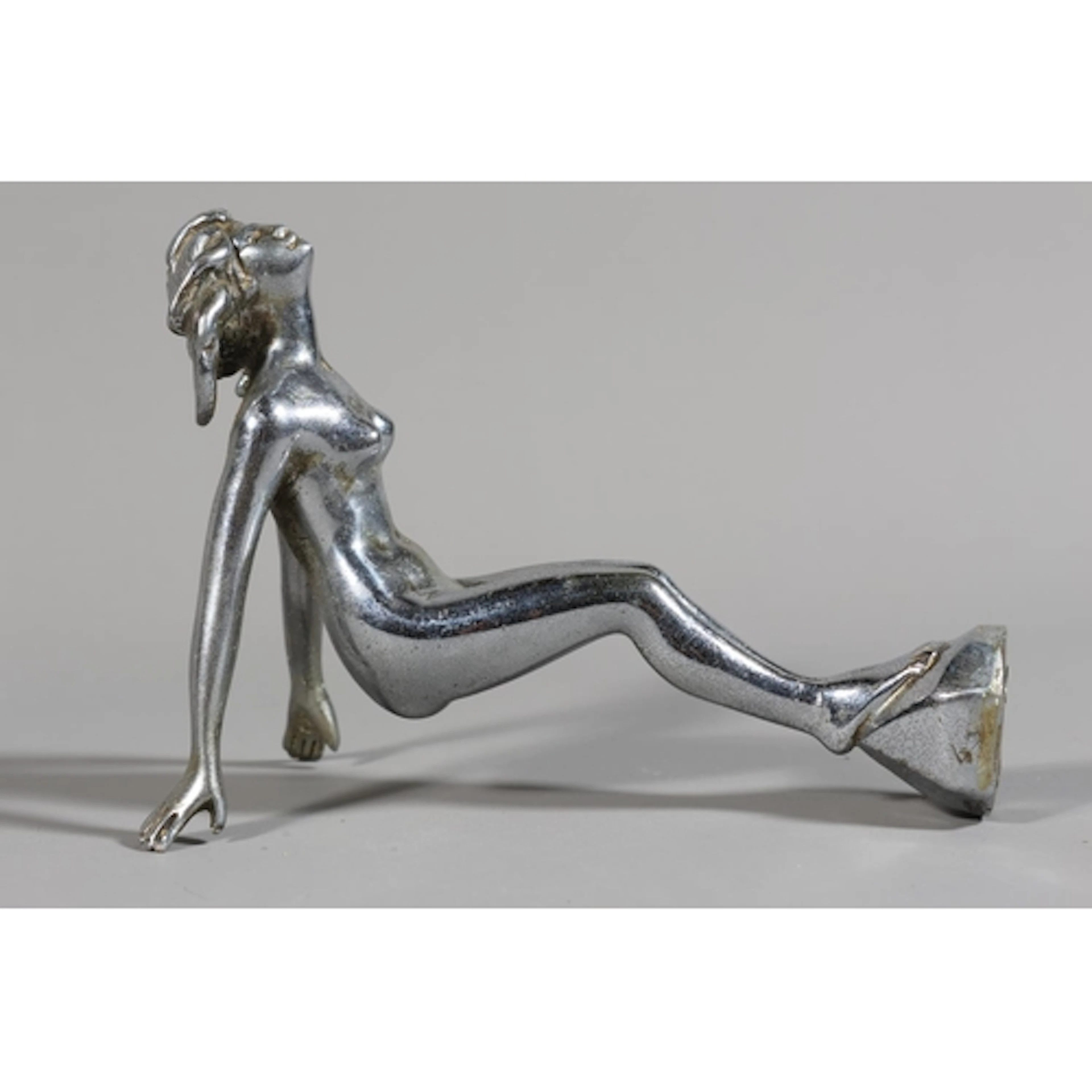 Chrome car mascot modelled as a female diving.