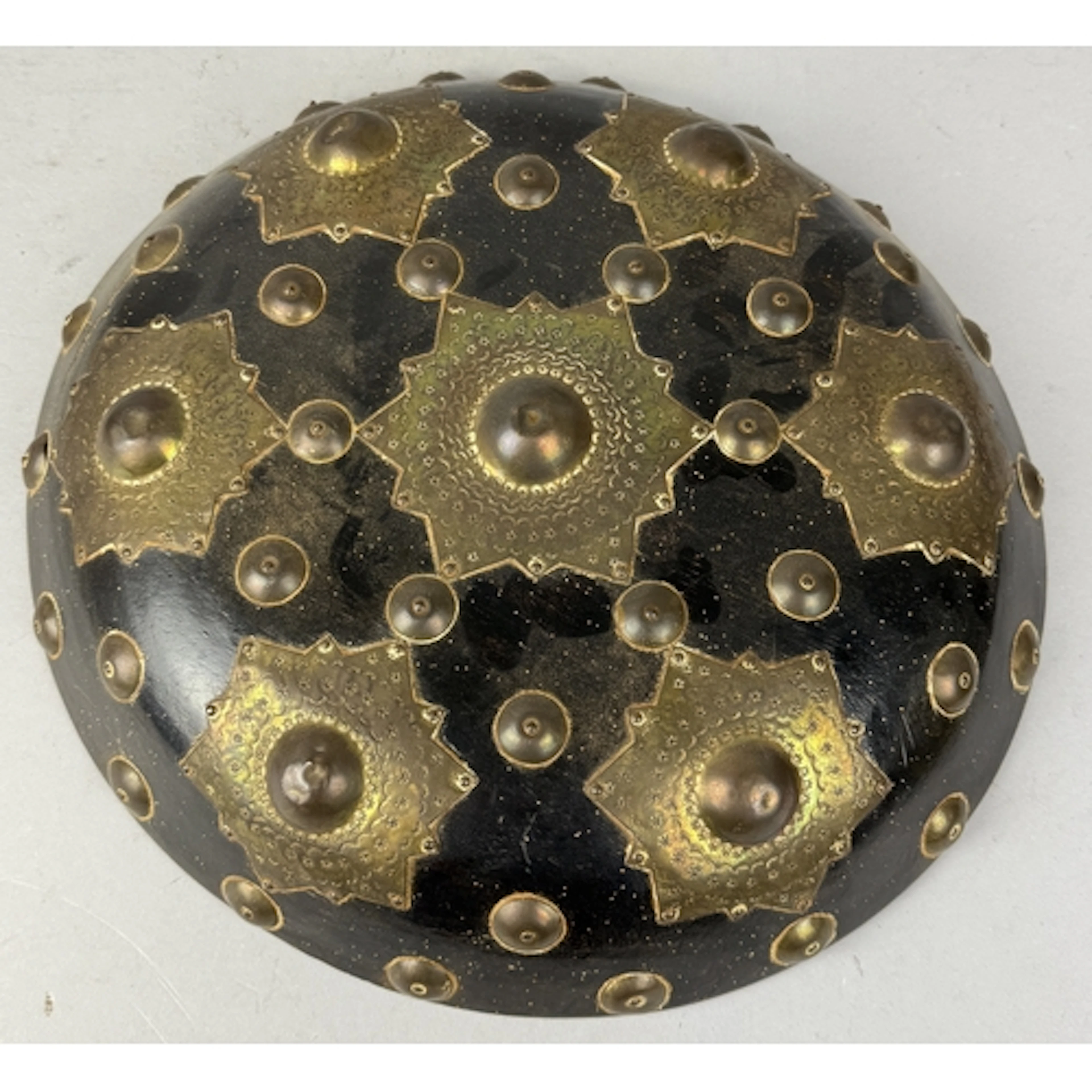 AN INDONESIAN SHIELD OR BUCKLER, WOOD WITH APPLIED BRASS ORN...
