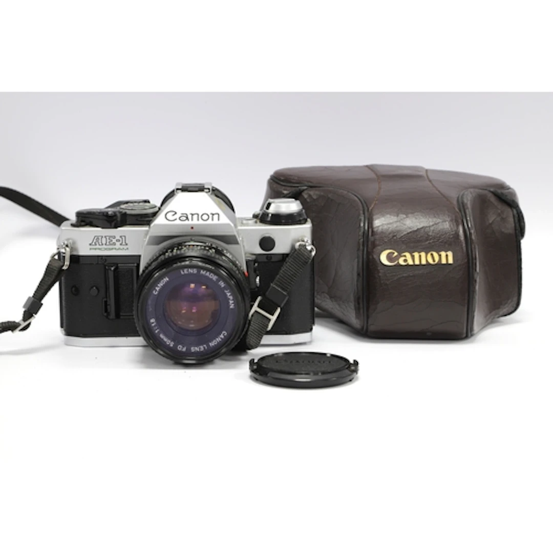 Canon AE-1 Program 35mm SLR Film Camera with attached Canon ...