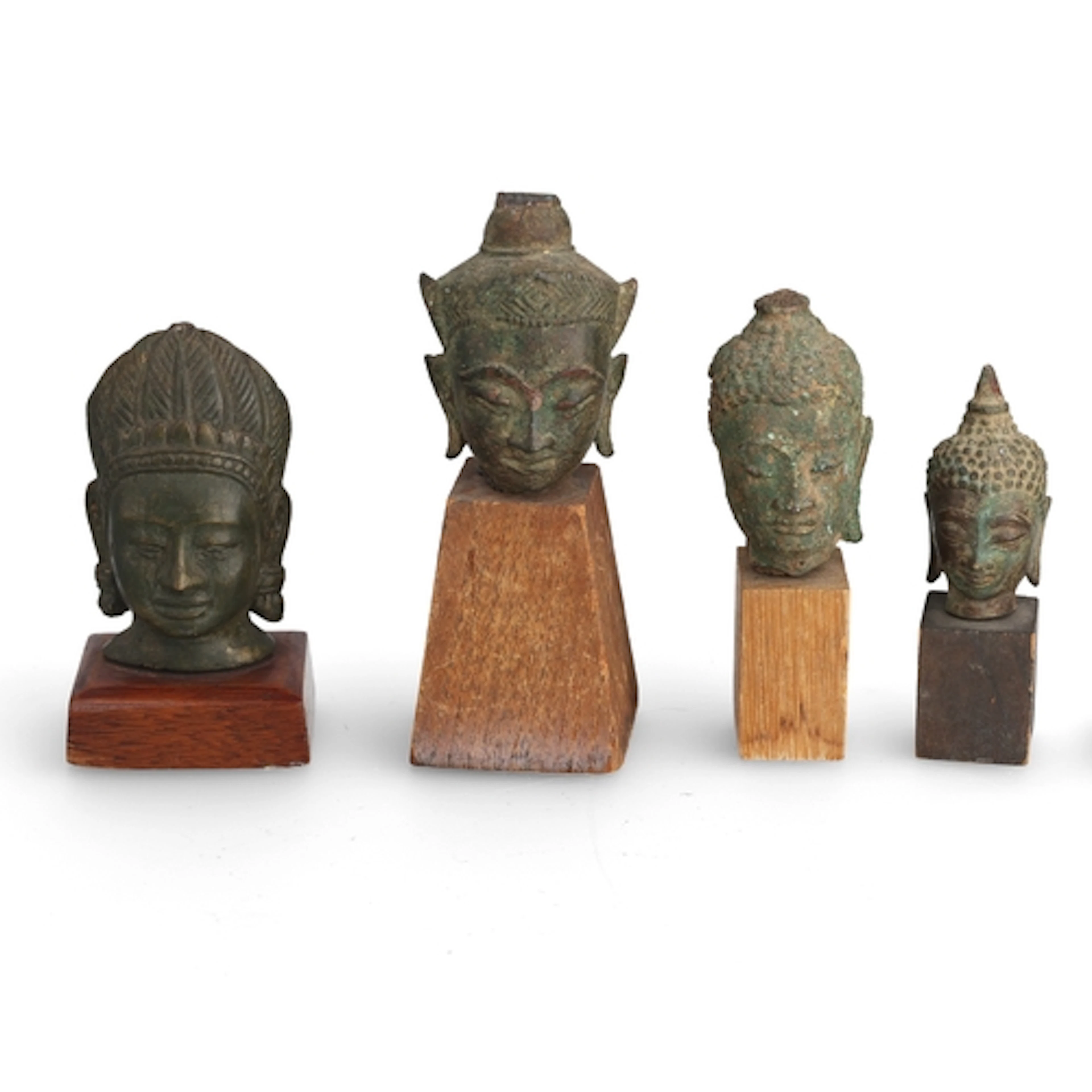 A GROUP OF FOUR 19TH C OR EARLIER BRONZE BUDDHA HEADS ON STA...