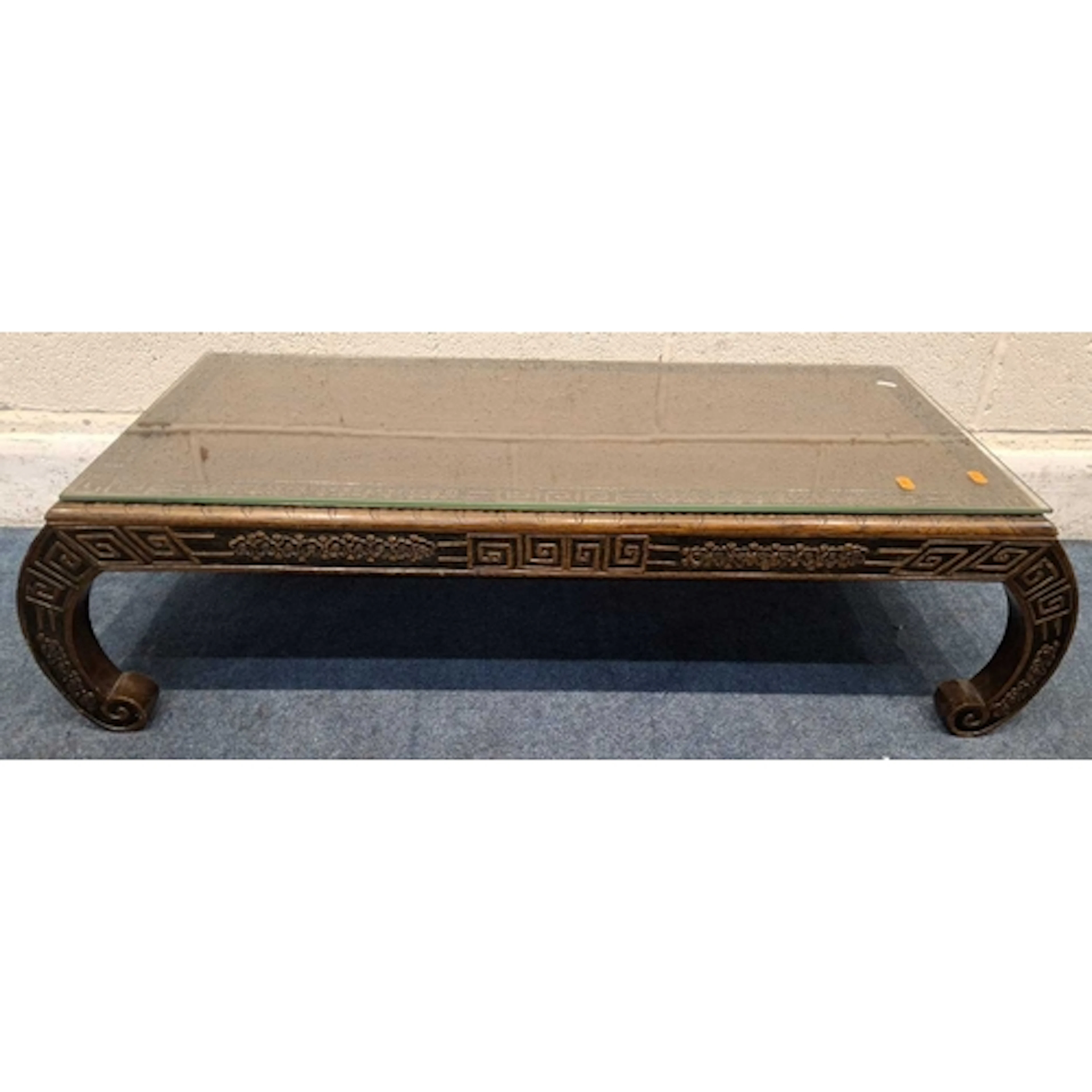 AN ORIENTAL HARDWOOD COFFEE TABLE, with various carved detai...