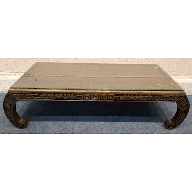 AN ORIENTAL HARDWOOD COFFEE TABLE, with various carved detai...