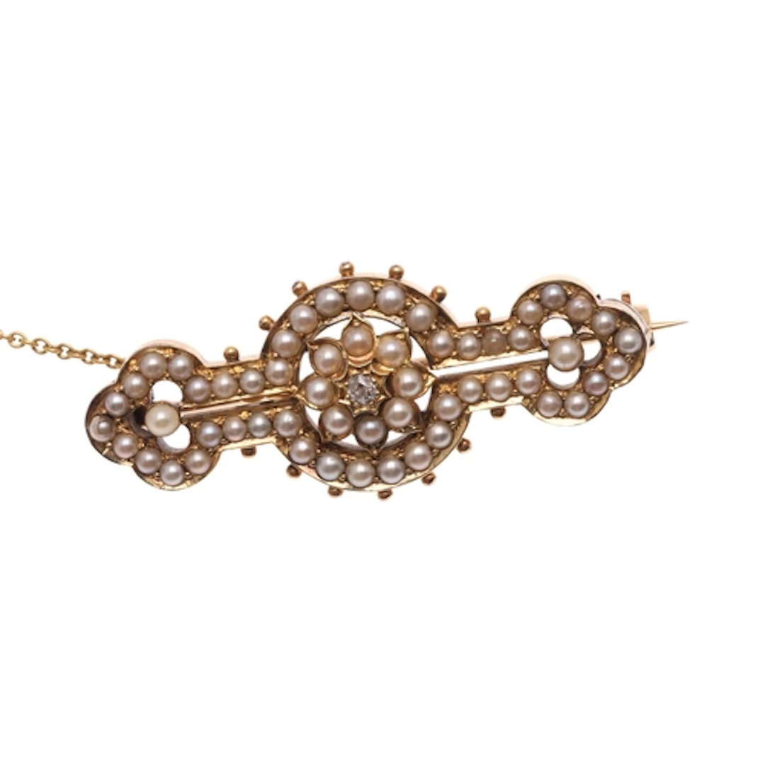 A VICTORIAN PEARL AND DIAMOND BROOCH. centred with a cushion...