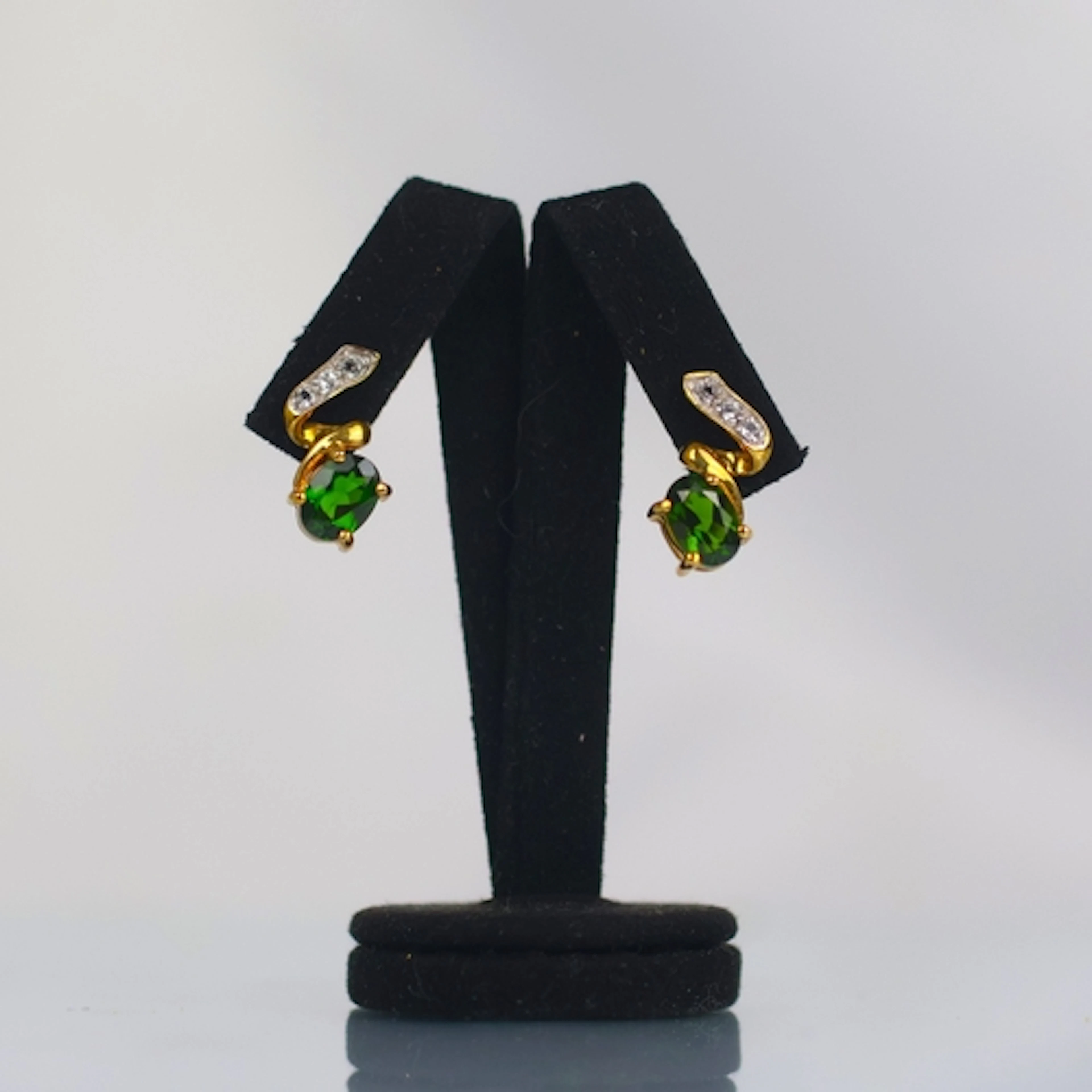 A pair of contemporary chrome diopside earrings, the oval cu...