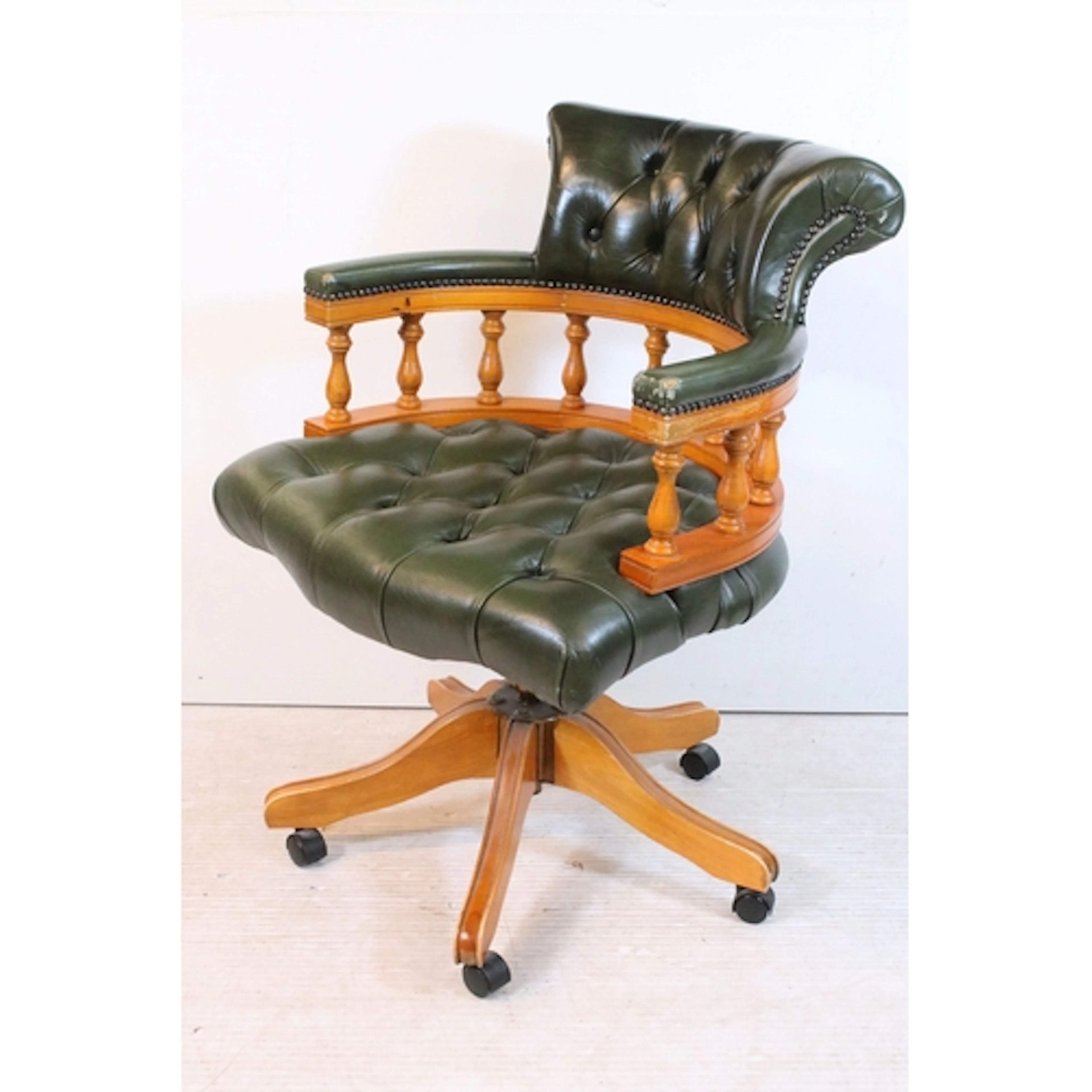 20th century yew wood captain's chair, with green leatherett...