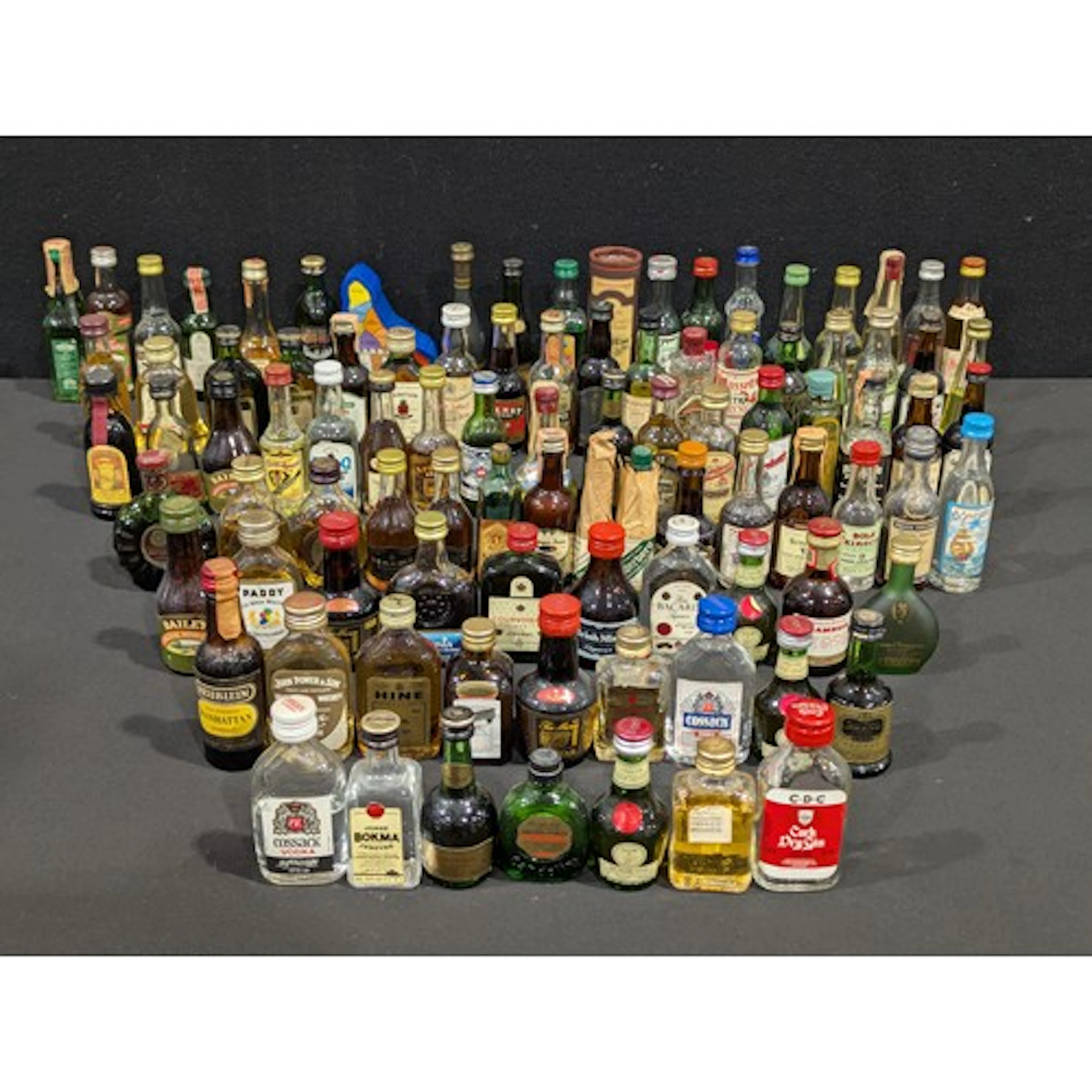 A assortment of miniature alcohol bottles; Remy Martin Champ...