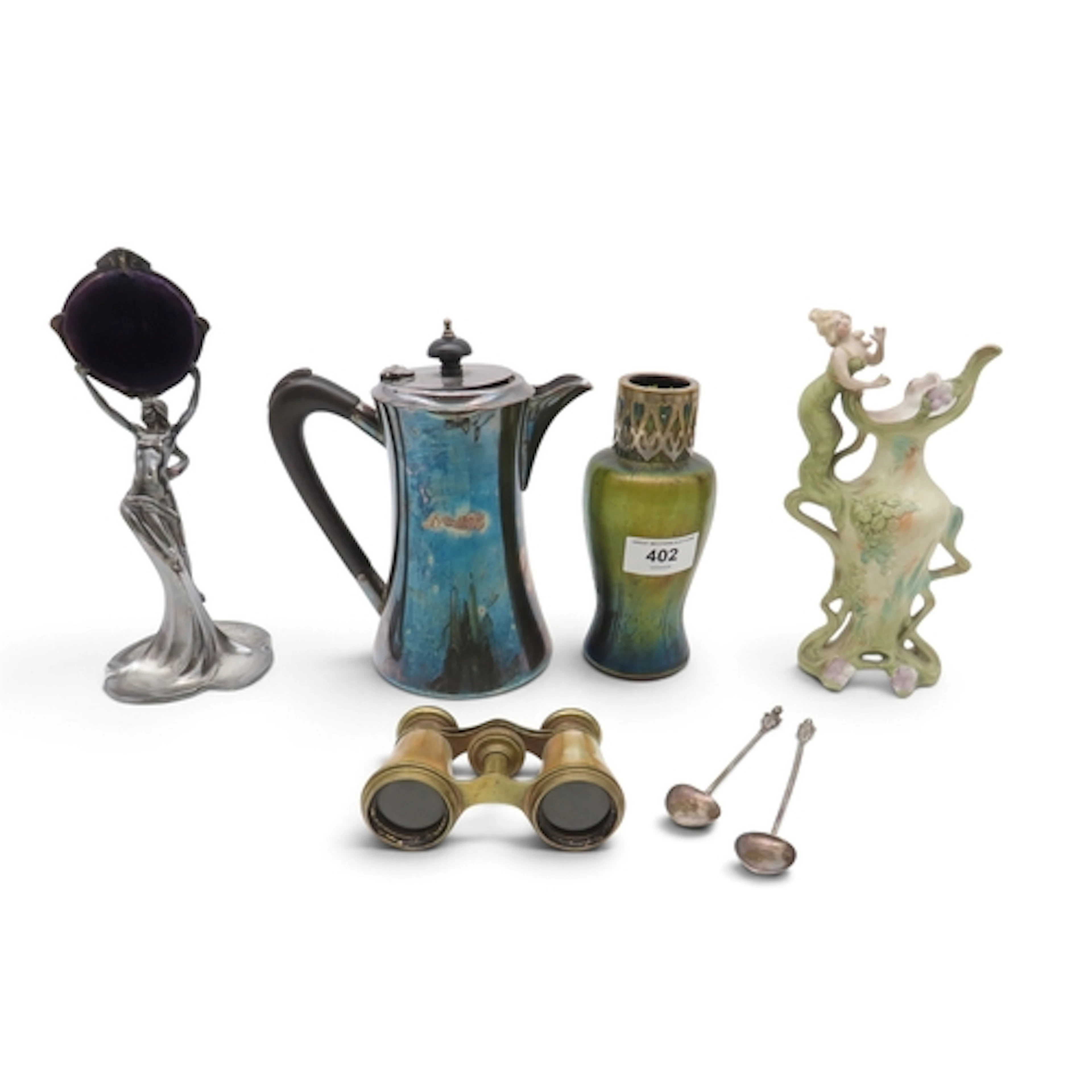 A WMF watch holder modelled as a maiden, an iridescent glass...