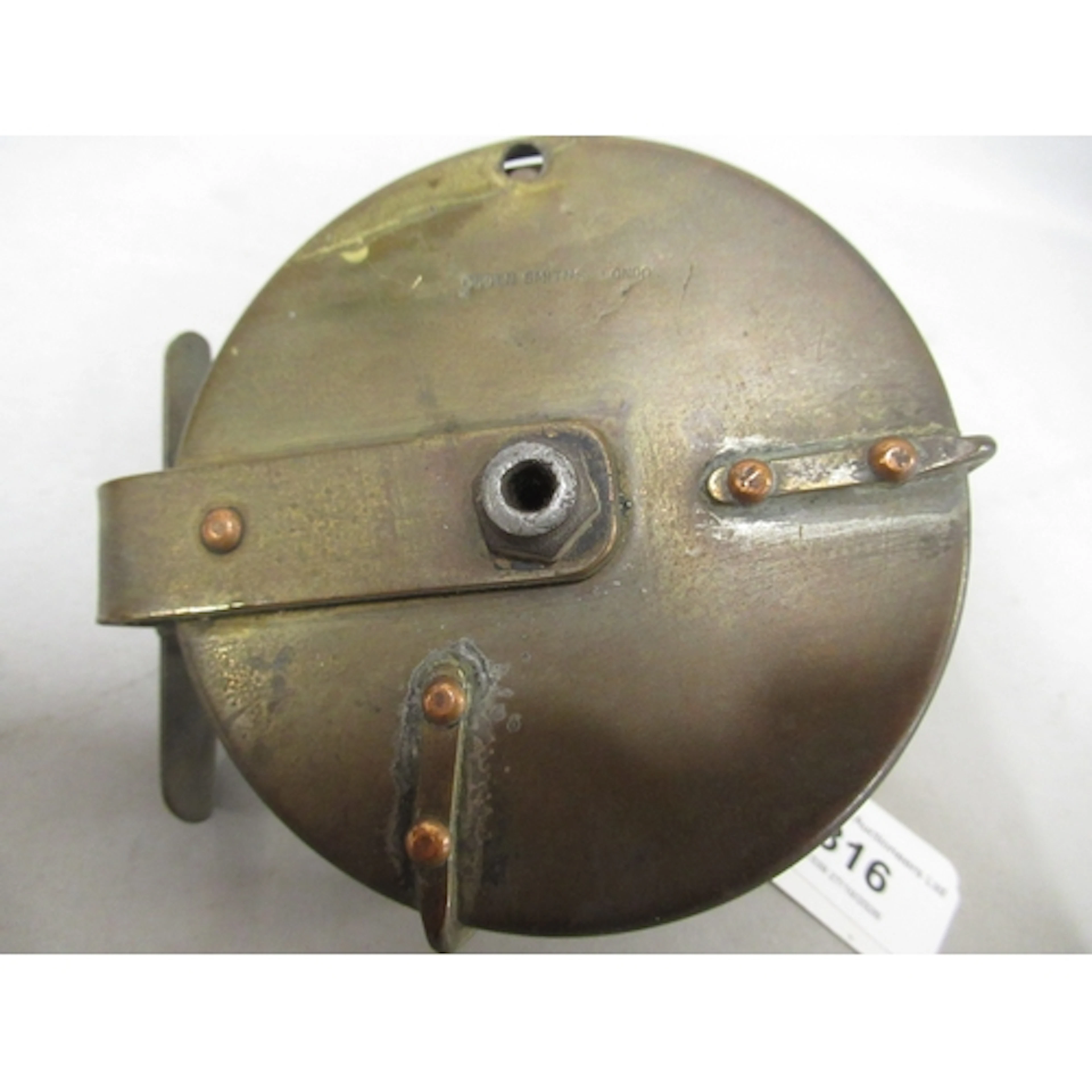Ogden Smiths, a brass twin handled centre pin reel, 4" diame...