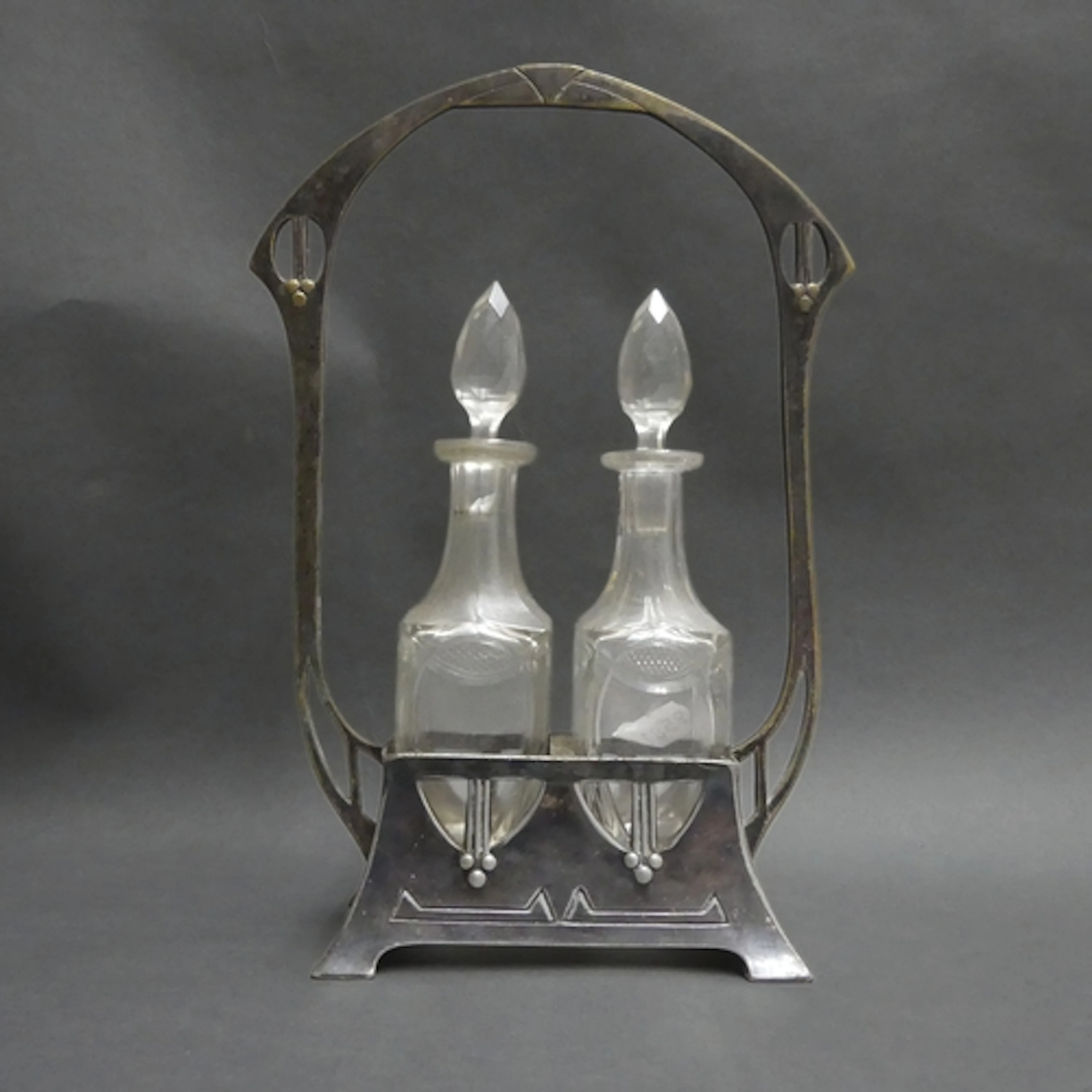 An Art Nouveau silver plated oil and vinegar cruet set, comp...