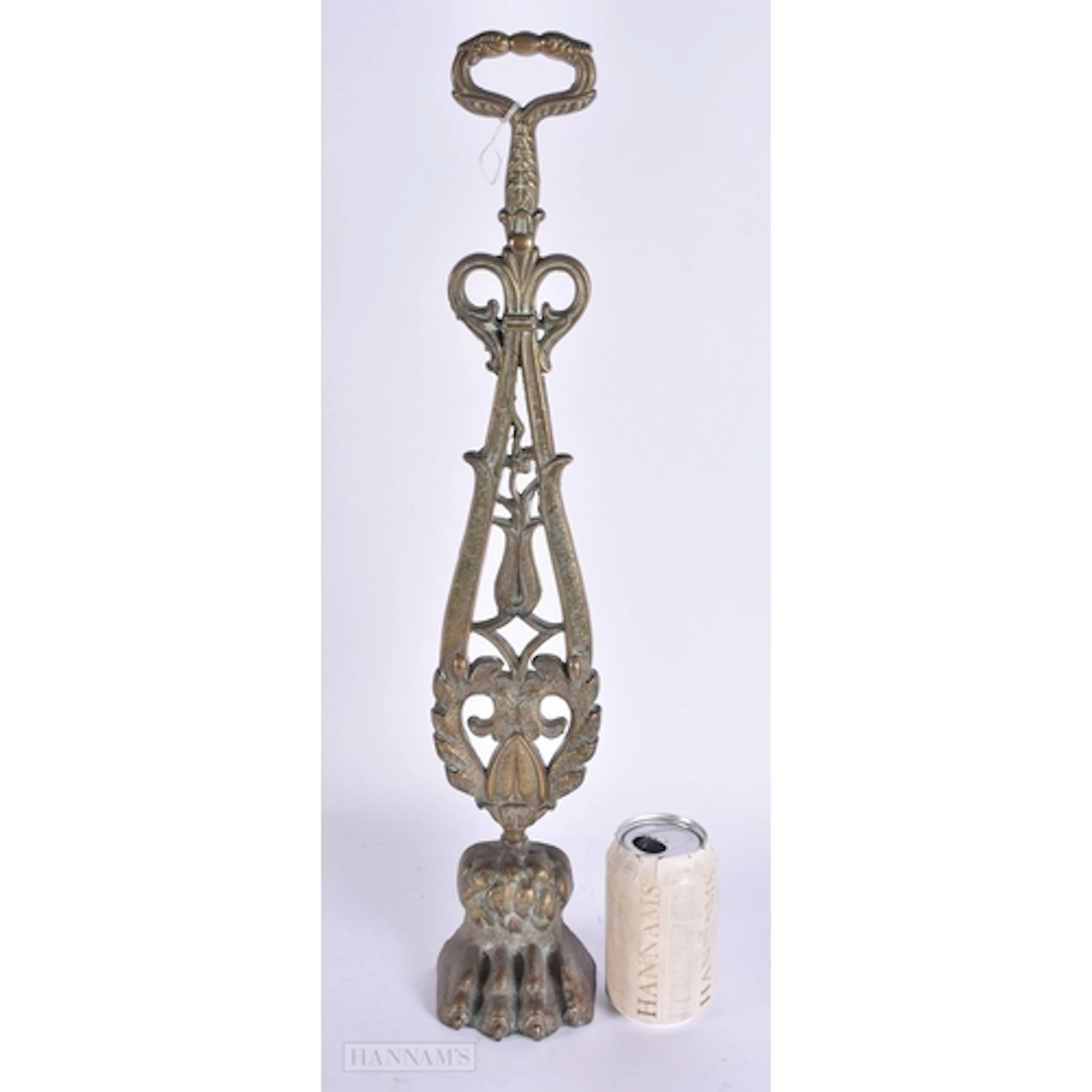 AN UNUSUAL George III BRONZE PAW FOOT DOOR STOP. 53 cm high.