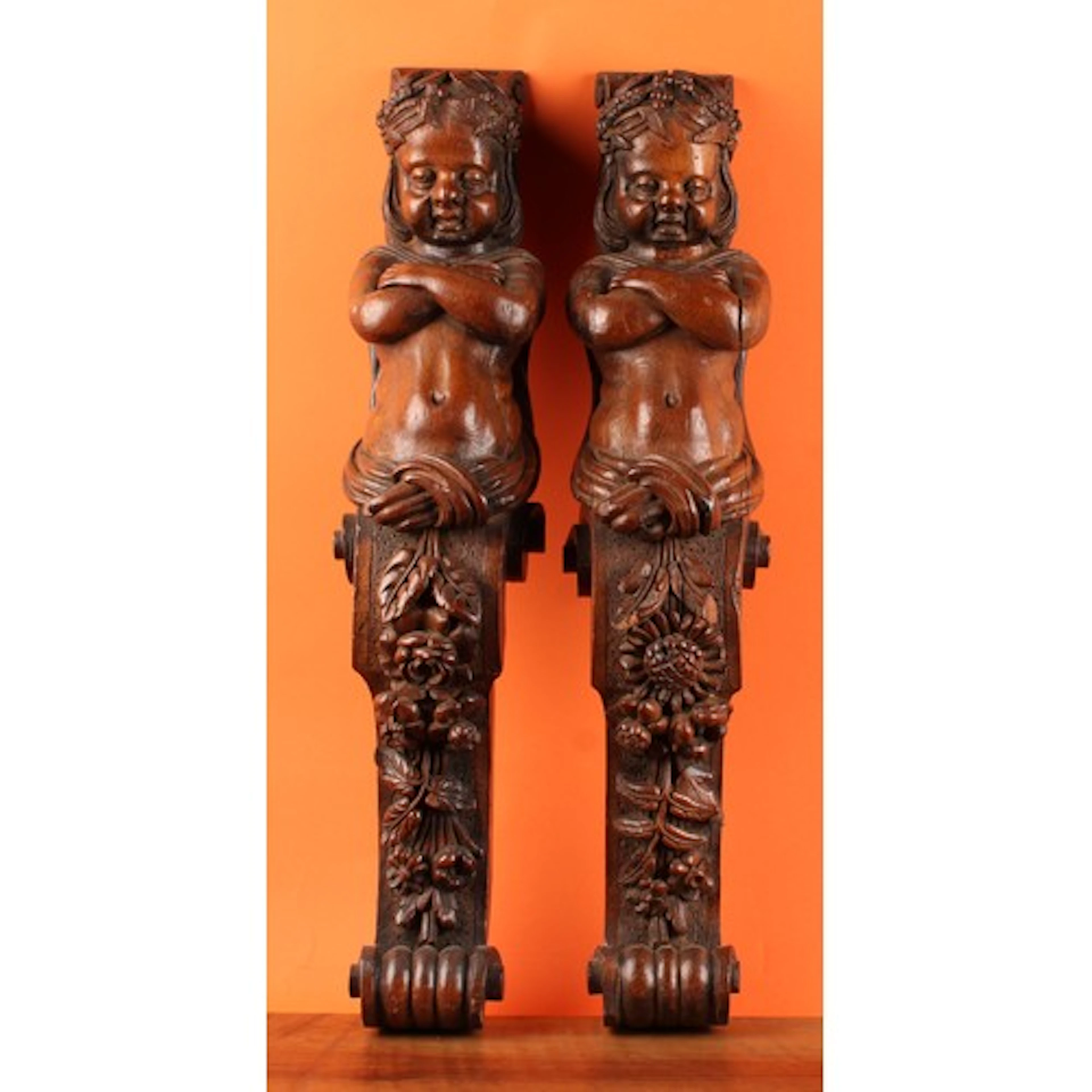 A pair of 19th century oak figural pilasters, each boldly ca...