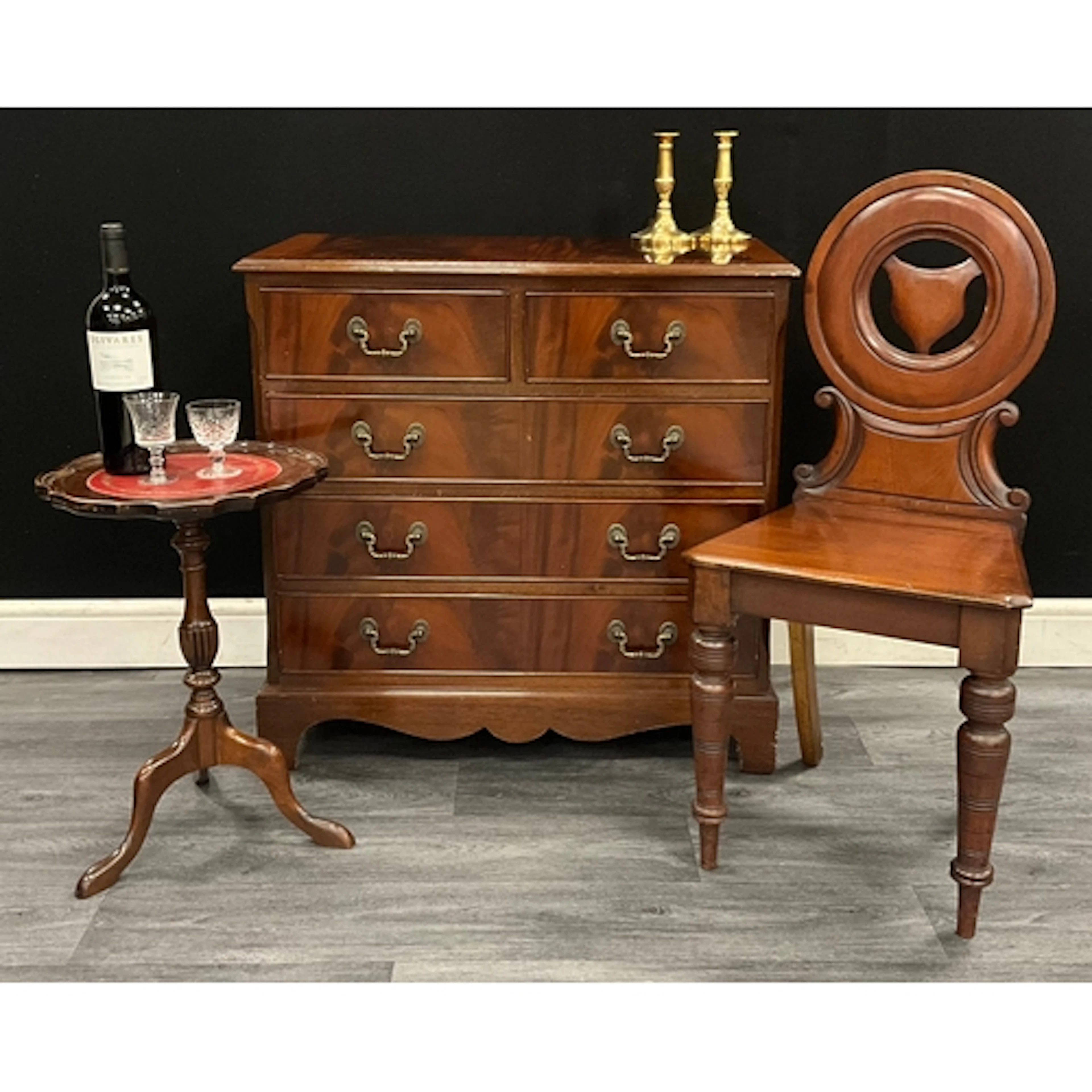 A Georgian style flame mahogany chest of drawers with cross ...