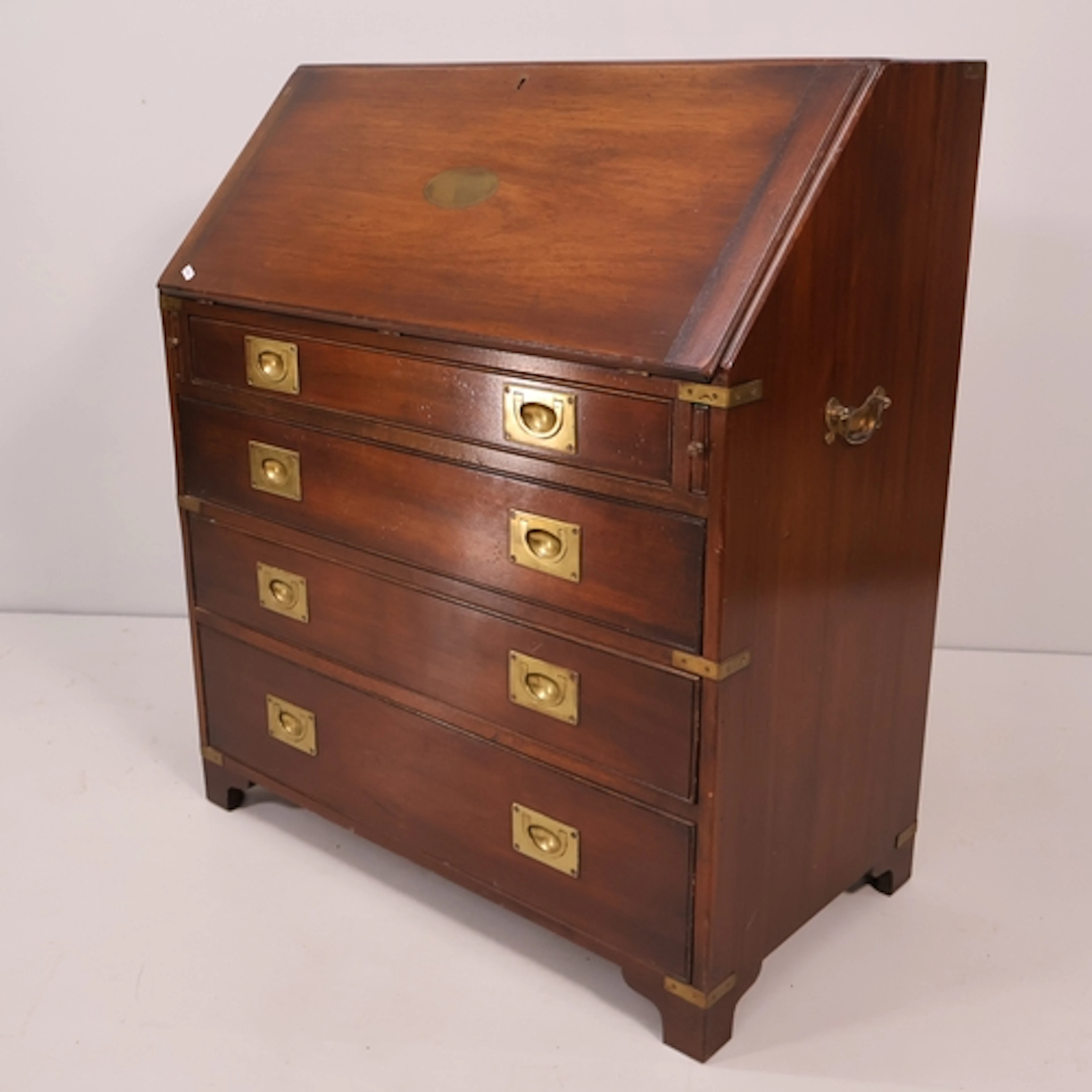 A campaign style mahogany bureau, four drawers with inset ha...