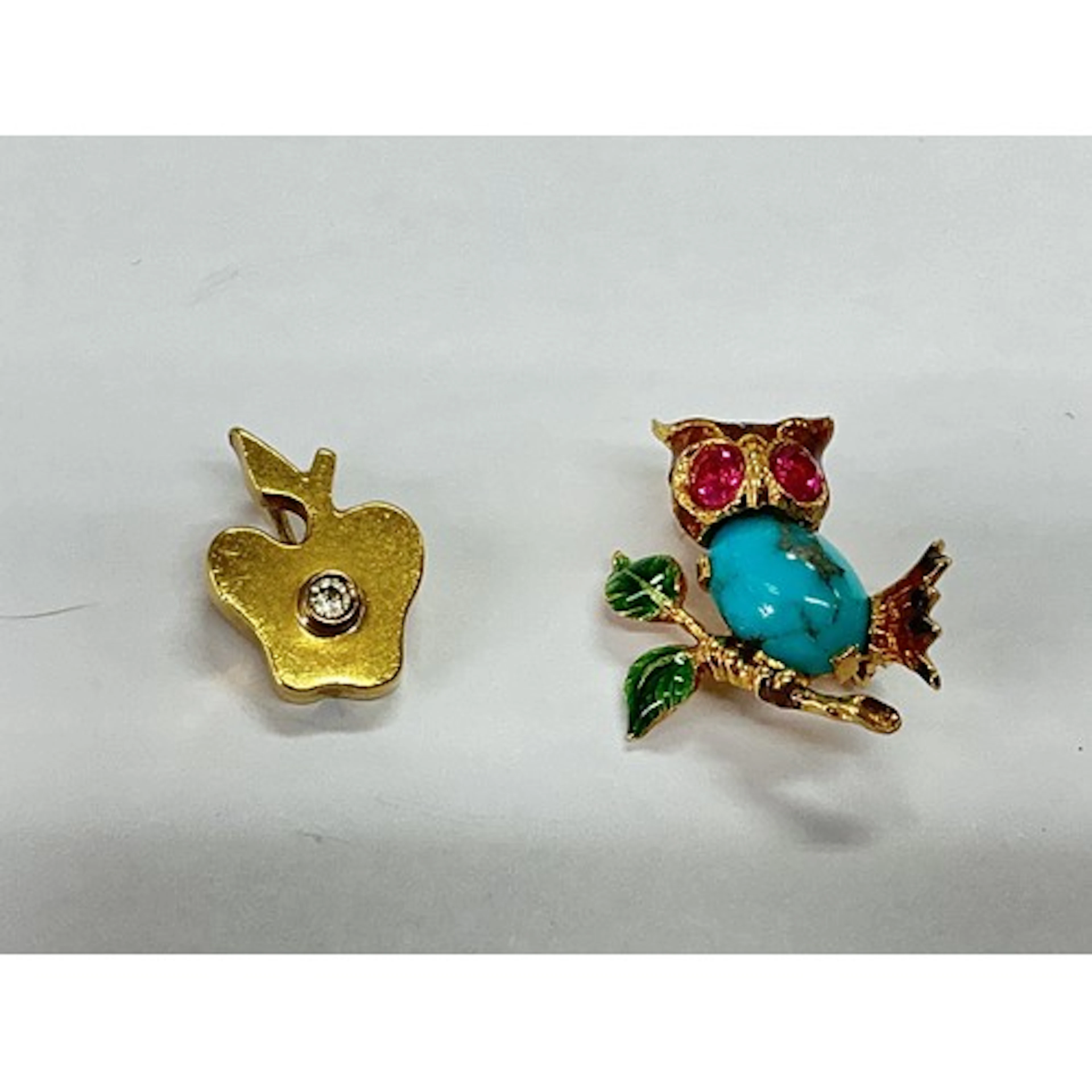 Two small gold brooches, one of an apple with a diamond chip...