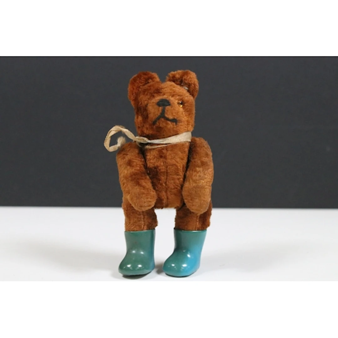 Mid 20th C miniature brown straw filled teddy bear, with blu...