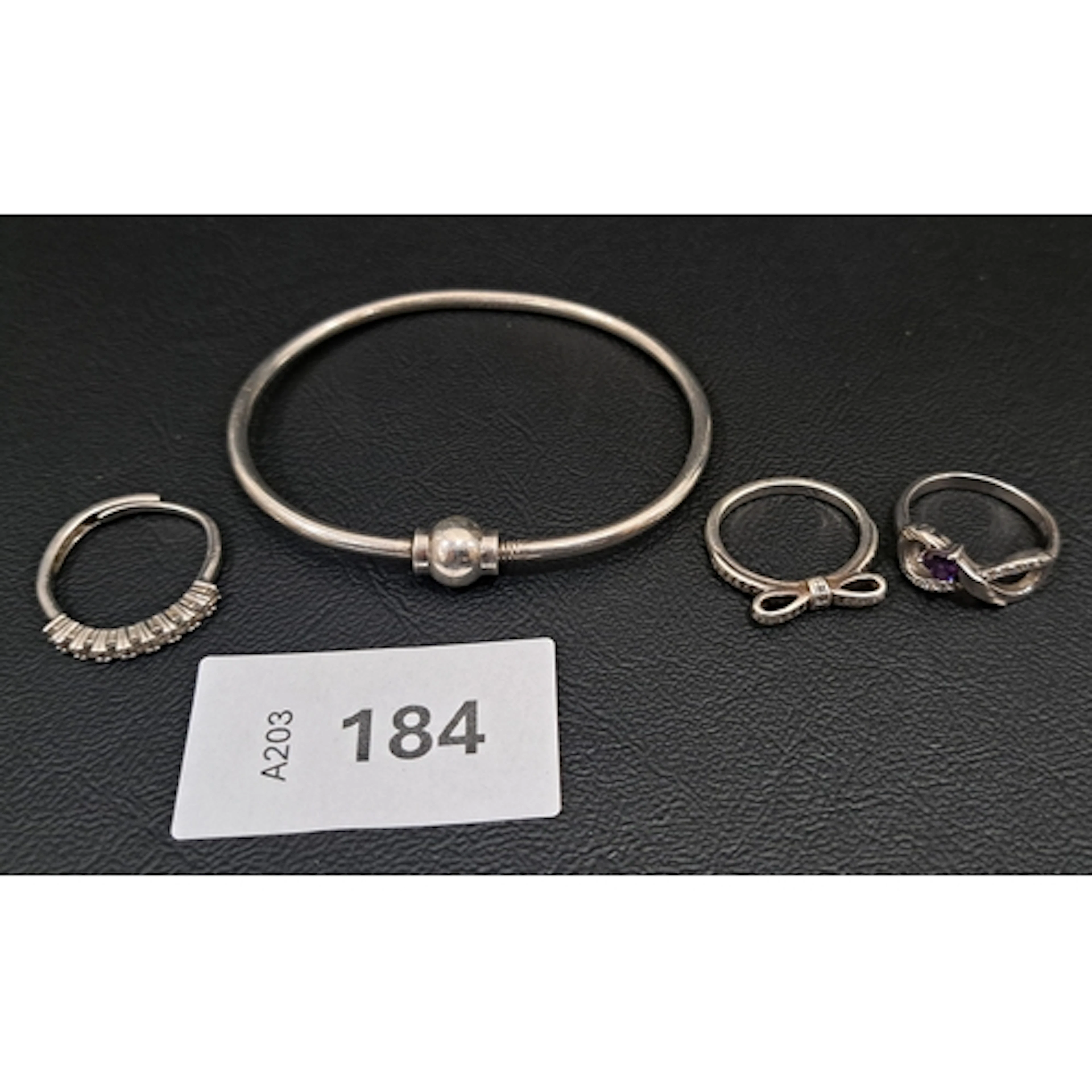 FOUR PIECES OF SILVER JEWELLERY comprising a bangle with sc...
