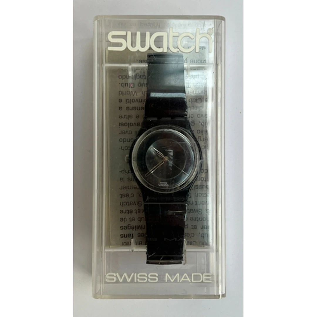 A black Swatch watch in original box