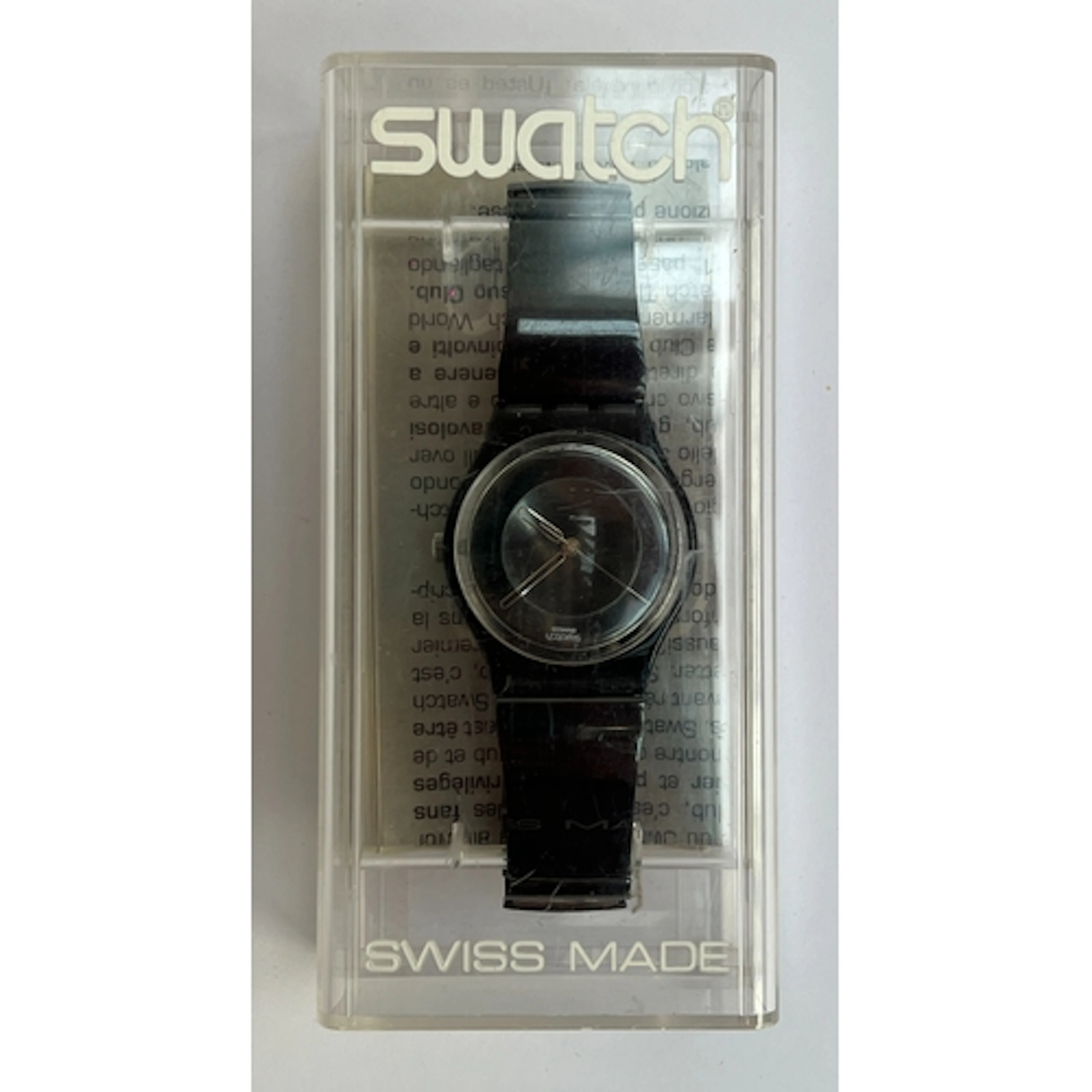 A black Swatch watch in original box