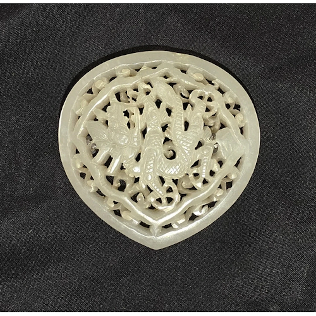 A Chinese 18/19th century reticulated white jade 'Dragon' Pl...