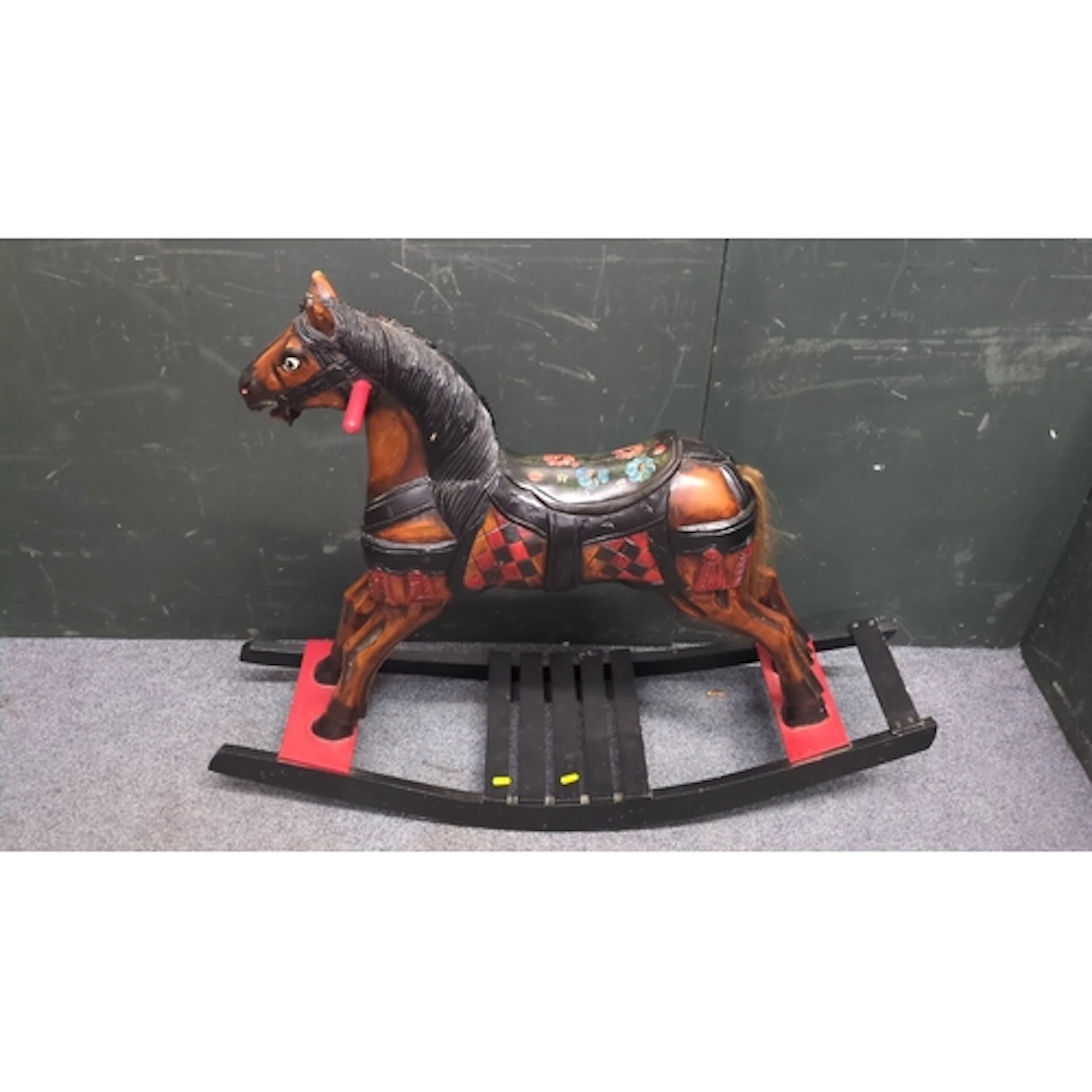 Polychrome-painted wooden rocking horse, the carved head wit...
