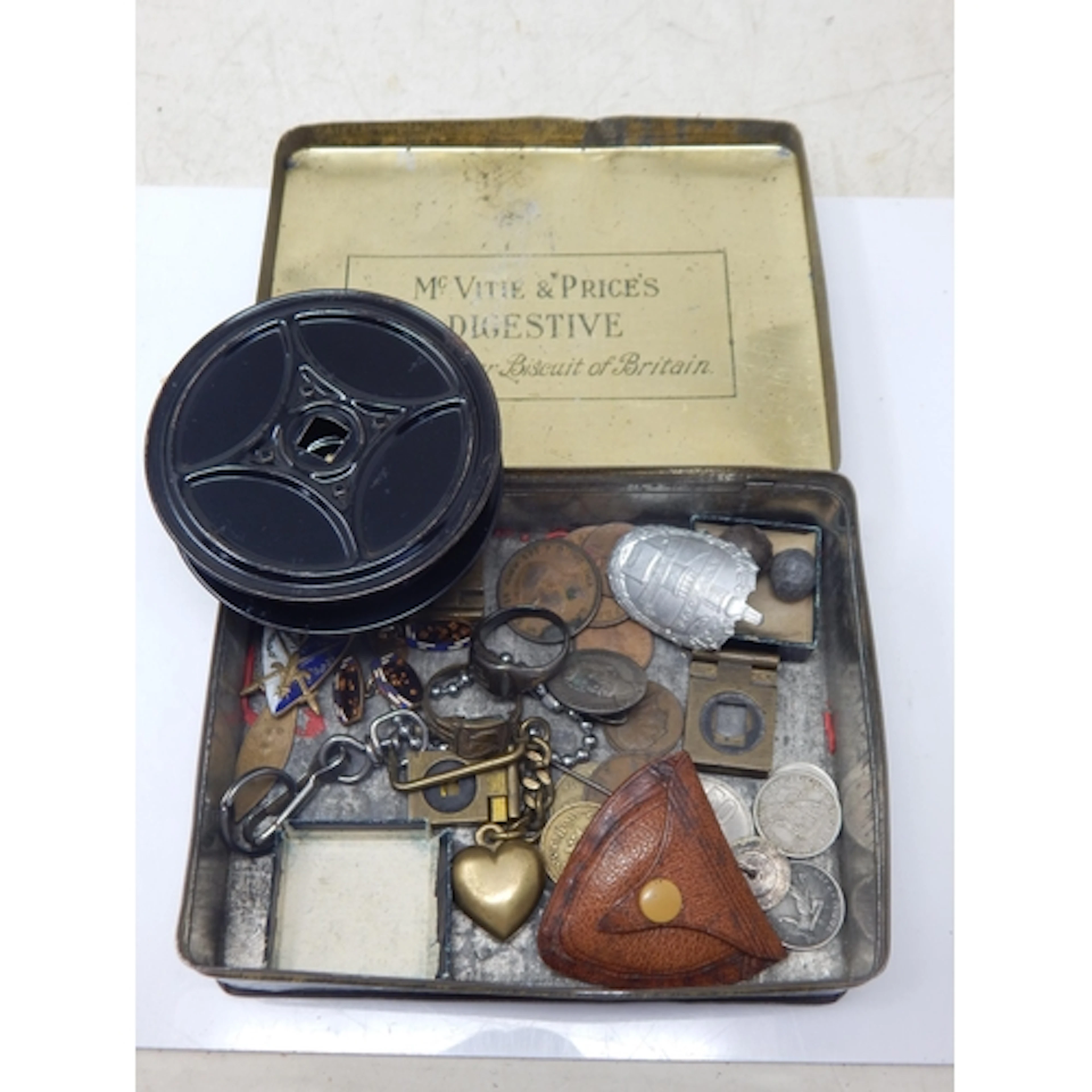 A Vintage Tin containing an assortment of items including WW...