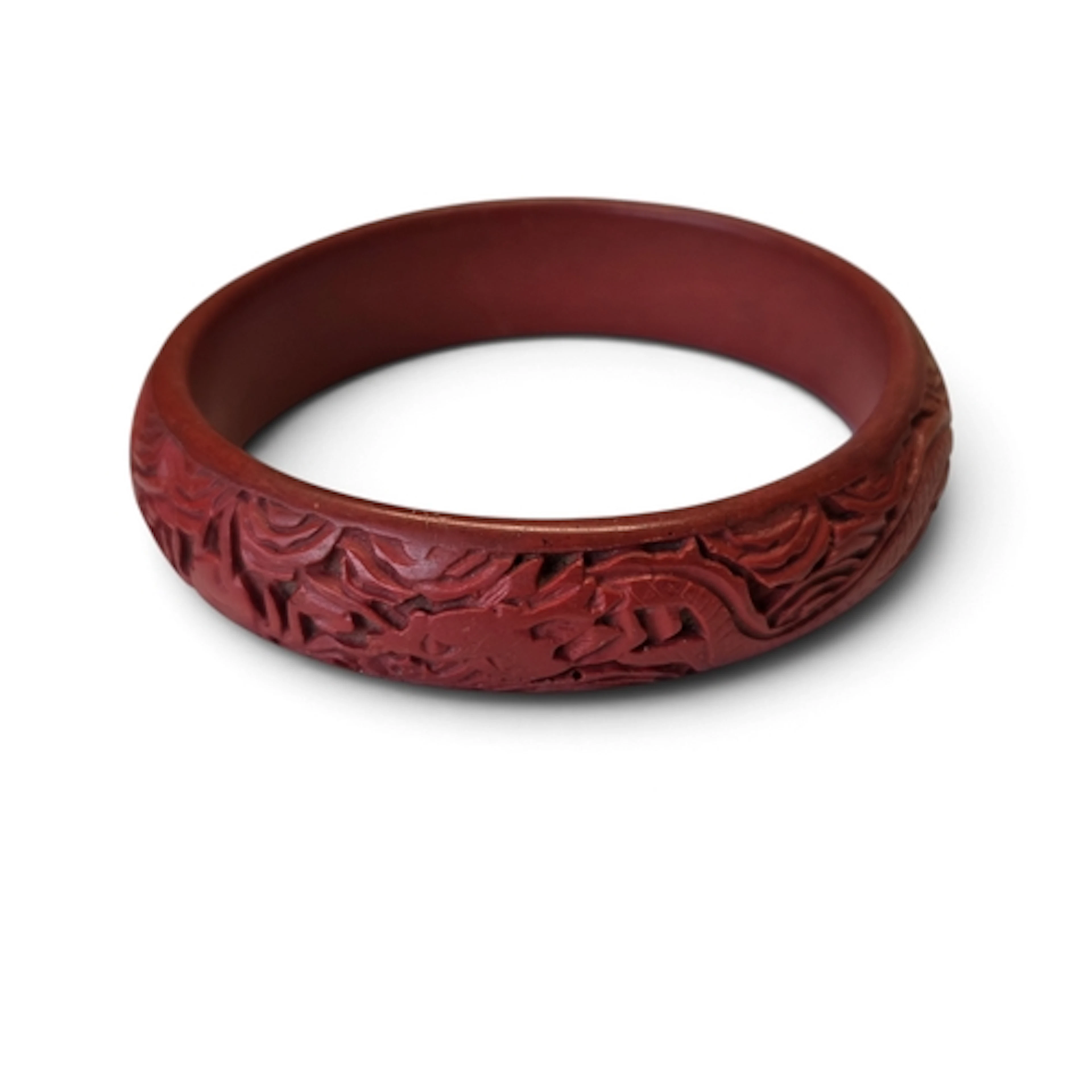 A Chinese Cinnamon coloured Bangle with a highly carved outl...