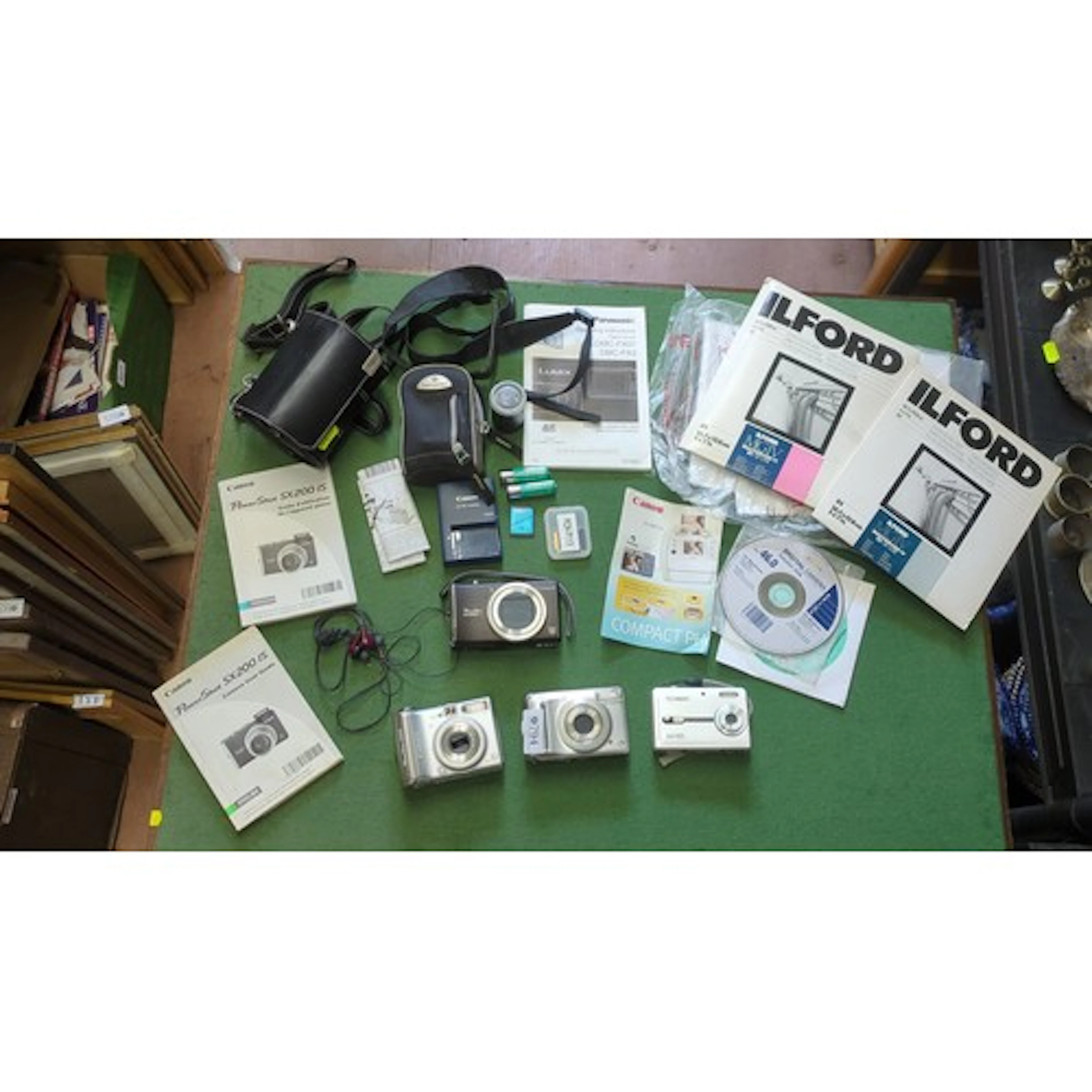 A group of compact digital cameras, including Canon PowerSho...