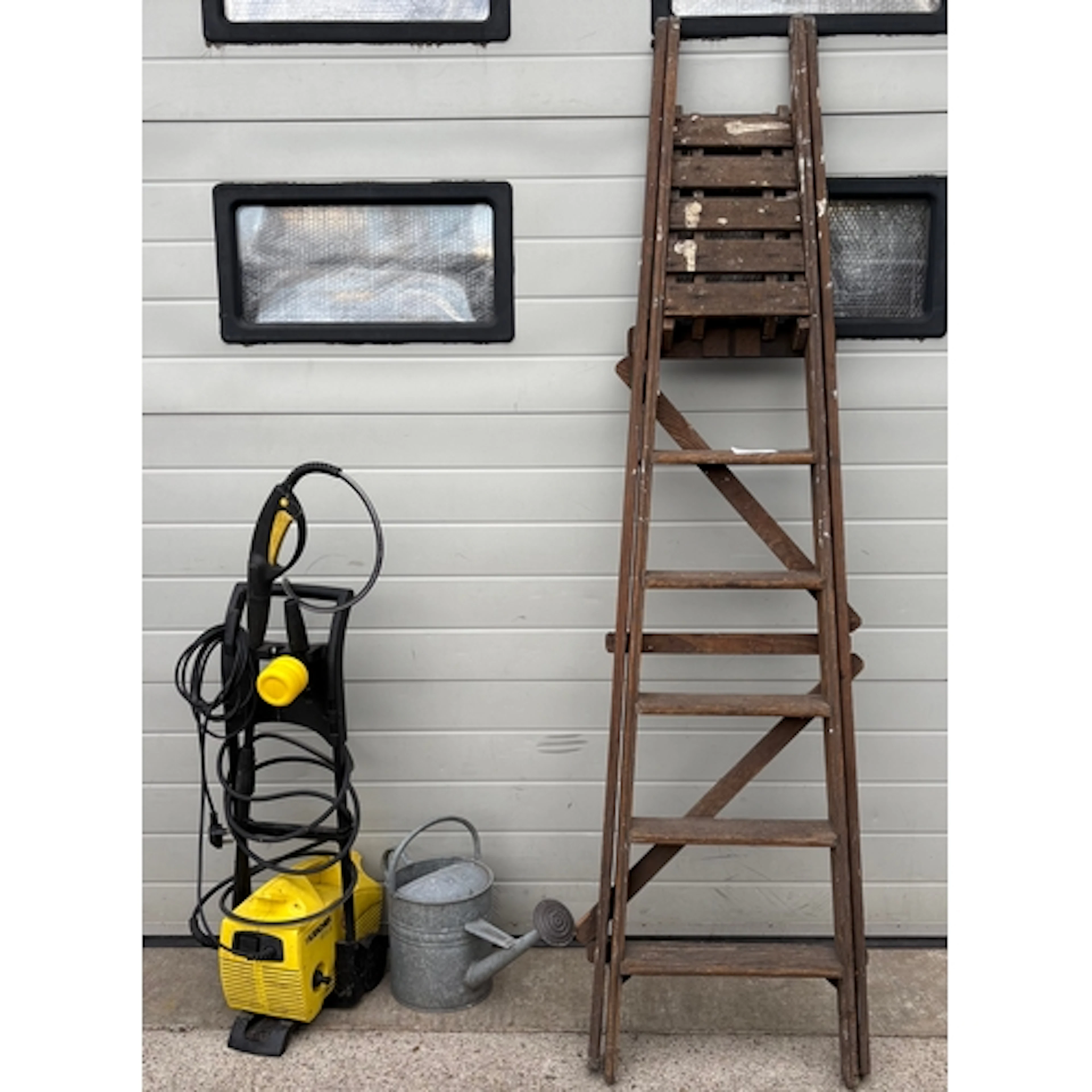 A set of wooden steps, galvanised watering can and a Karcher...