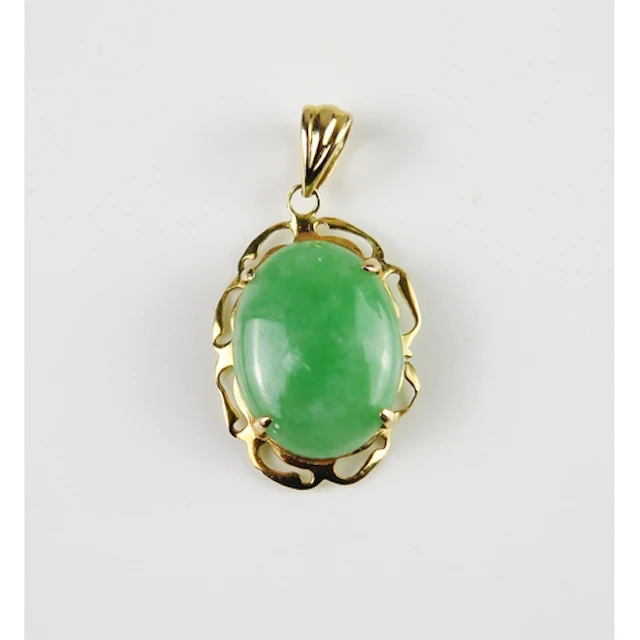 A jade pendant in a 14K yellow gold setting, 28.5mm drop, st...