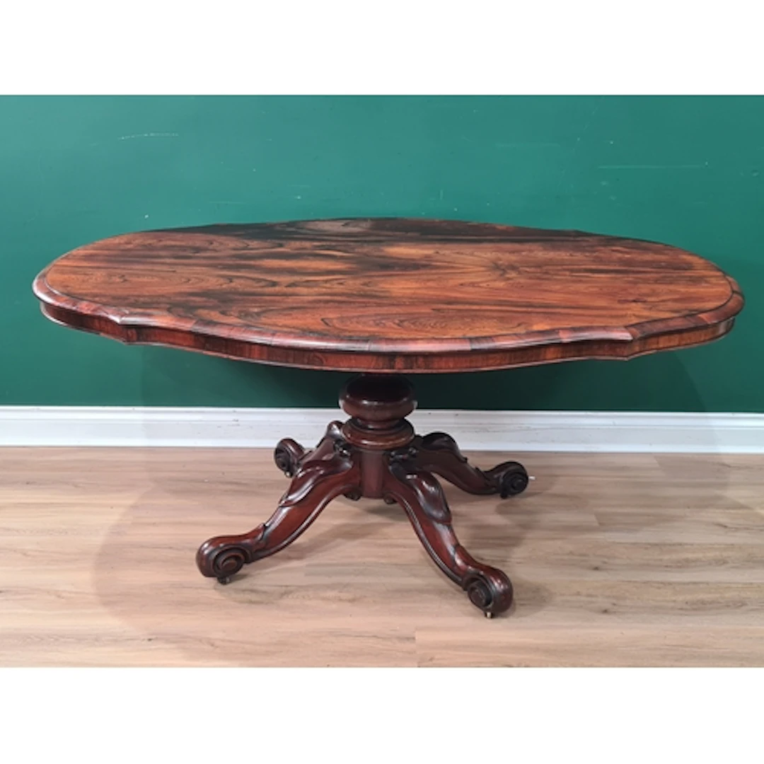 A Victorian rosewood shaped oval Breakfast Table on bulbous ...