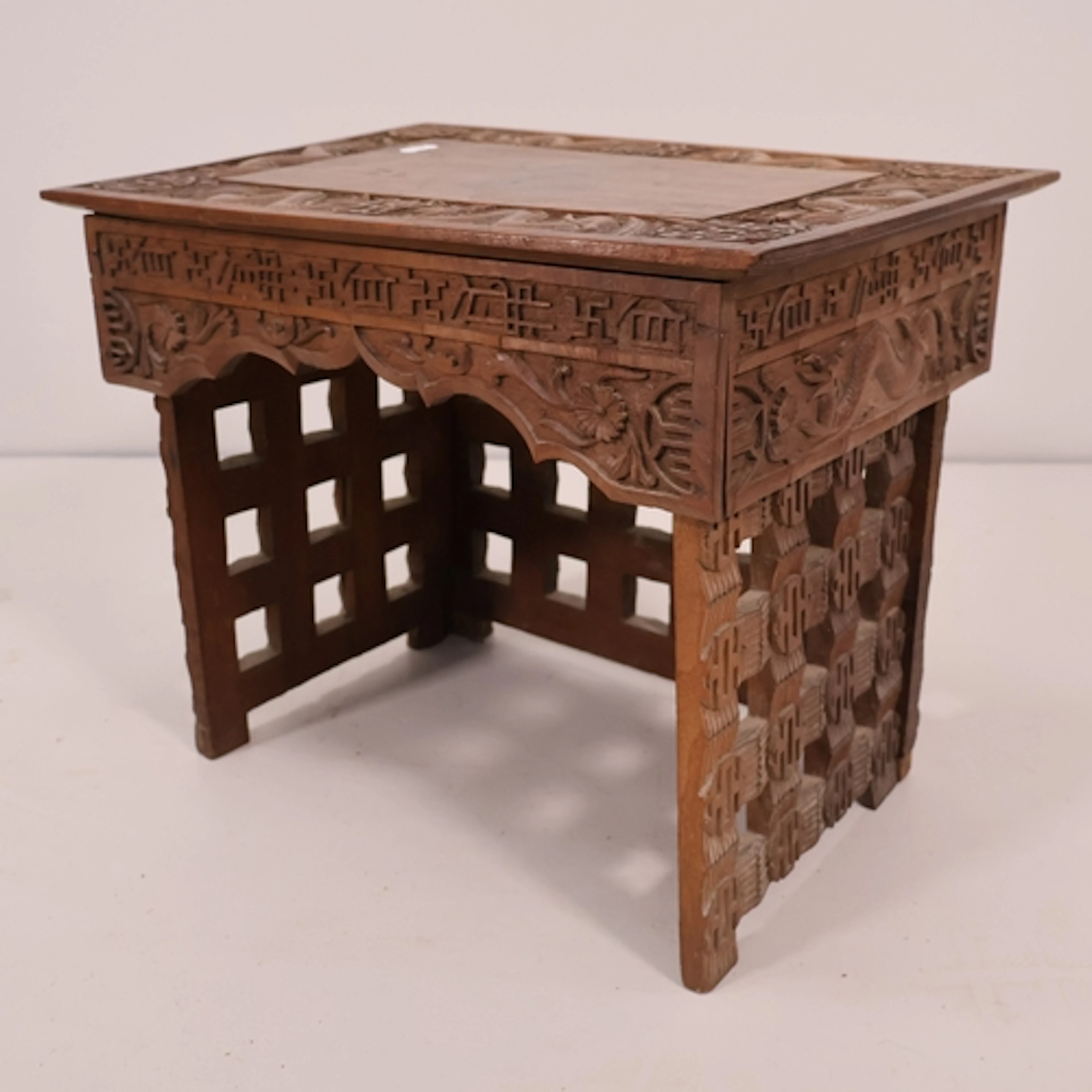 An antique Chinese hardwood folding Scribe's stool, with car...